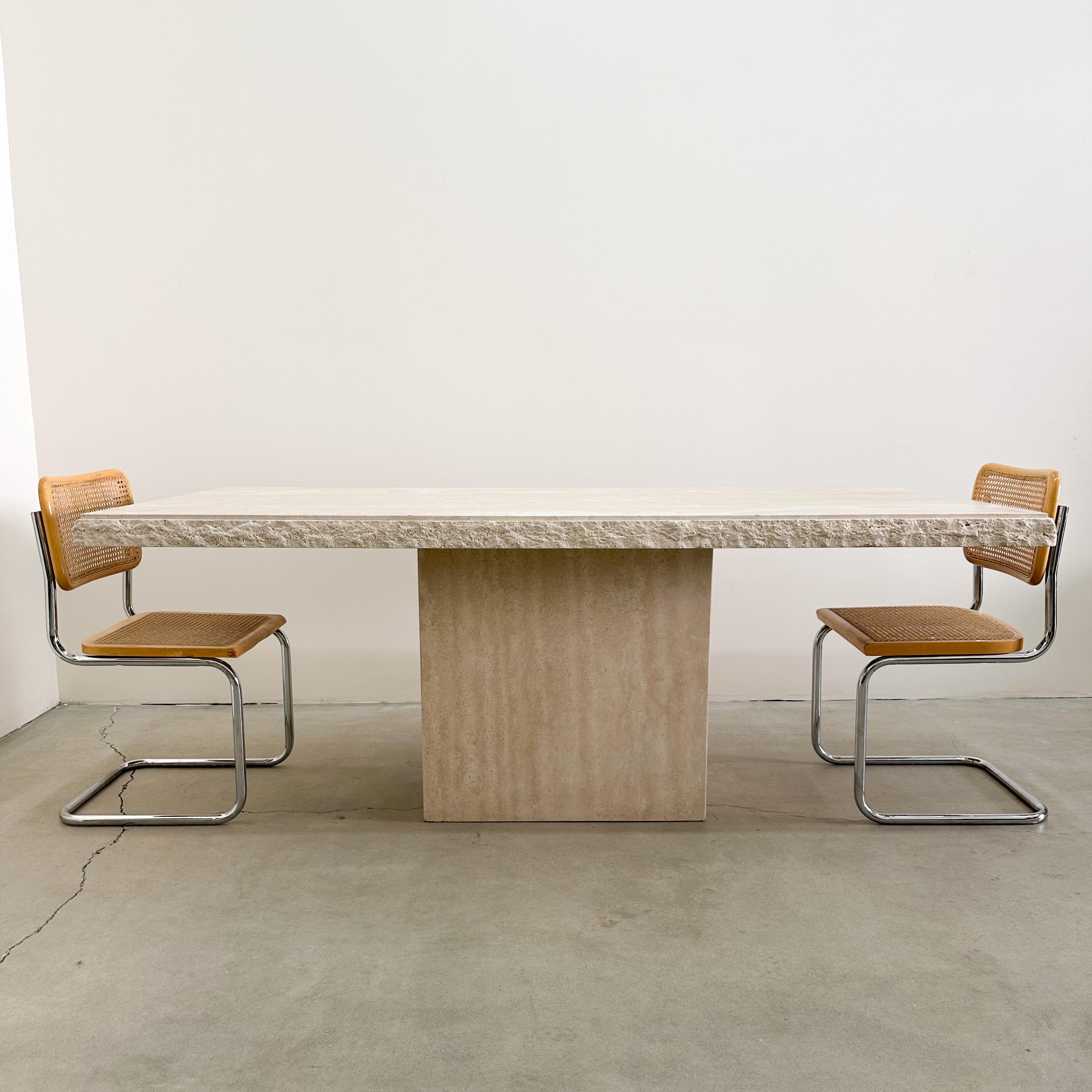 Vintage Rectangle Raw Edge Travertine Dining Table. 

Material: The table is made from solid travertine stone, which is known for its natural and timeless appeal.

Design: It's a two-part table with a tabletop that rests on a stand. The raw edge