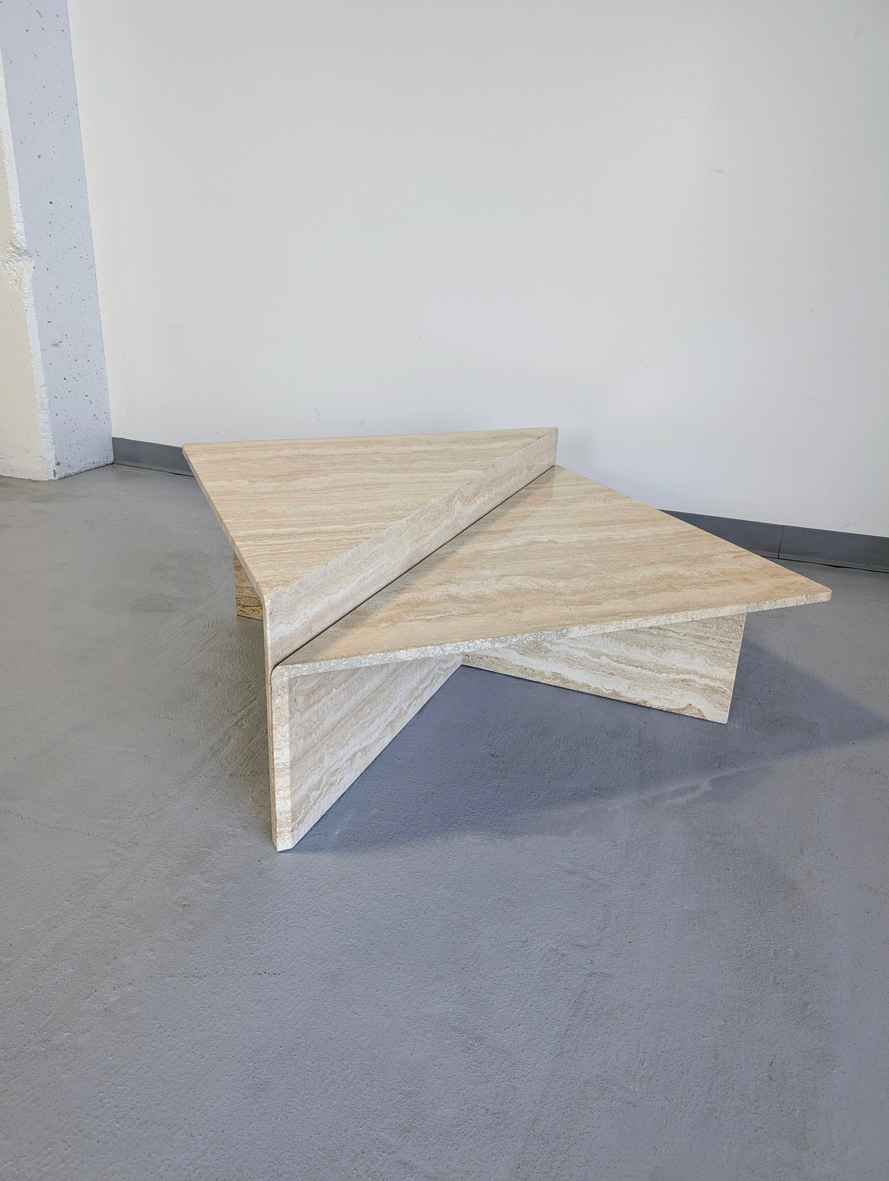 Large two piece set of Italian sculptural solid travertine coffee tables. Great modern forms. The set can be set in a variety of positions and layouts to be selected for your space.

Each table is 27.5