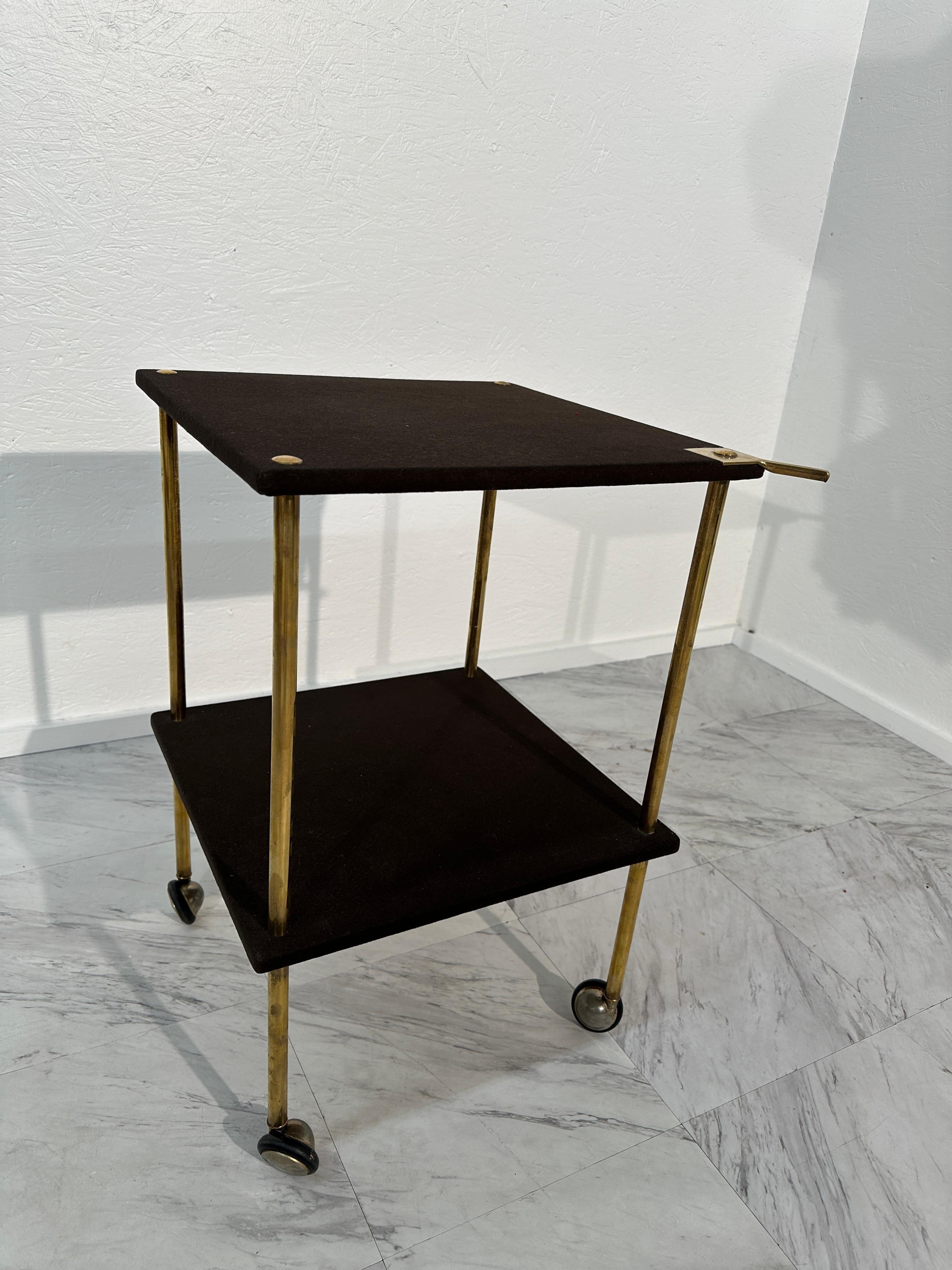 Embark on a journey through mid-century Italian design with the Vintage Trolley on Wheels T9 by Luigi Caccia Dominioni for Azucena, circa the 1960s. This iconic piece encapsulates Caccia Dominioni's commitment to both elegance and functionality. The