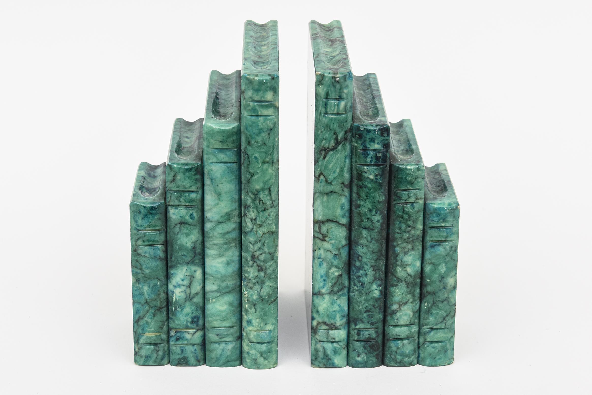 These fabulous turquoise sea green Italian vintage bookends are the form of books.
The original sticker on the bottom reads genuine alabaster Made In Italy with stickers of number of 76-1. They are play on play. The original felt on the bottom
