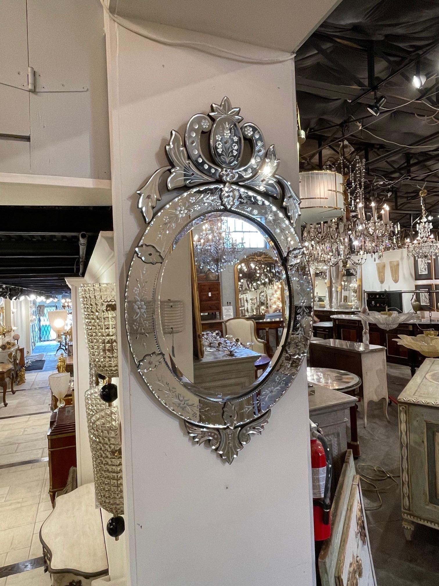 Exquisite oval shaped vintage Italian Venetian style etched glass mirror. Beautiful floral images etched in the glass and lovely crown at the top. Gorgeous!!