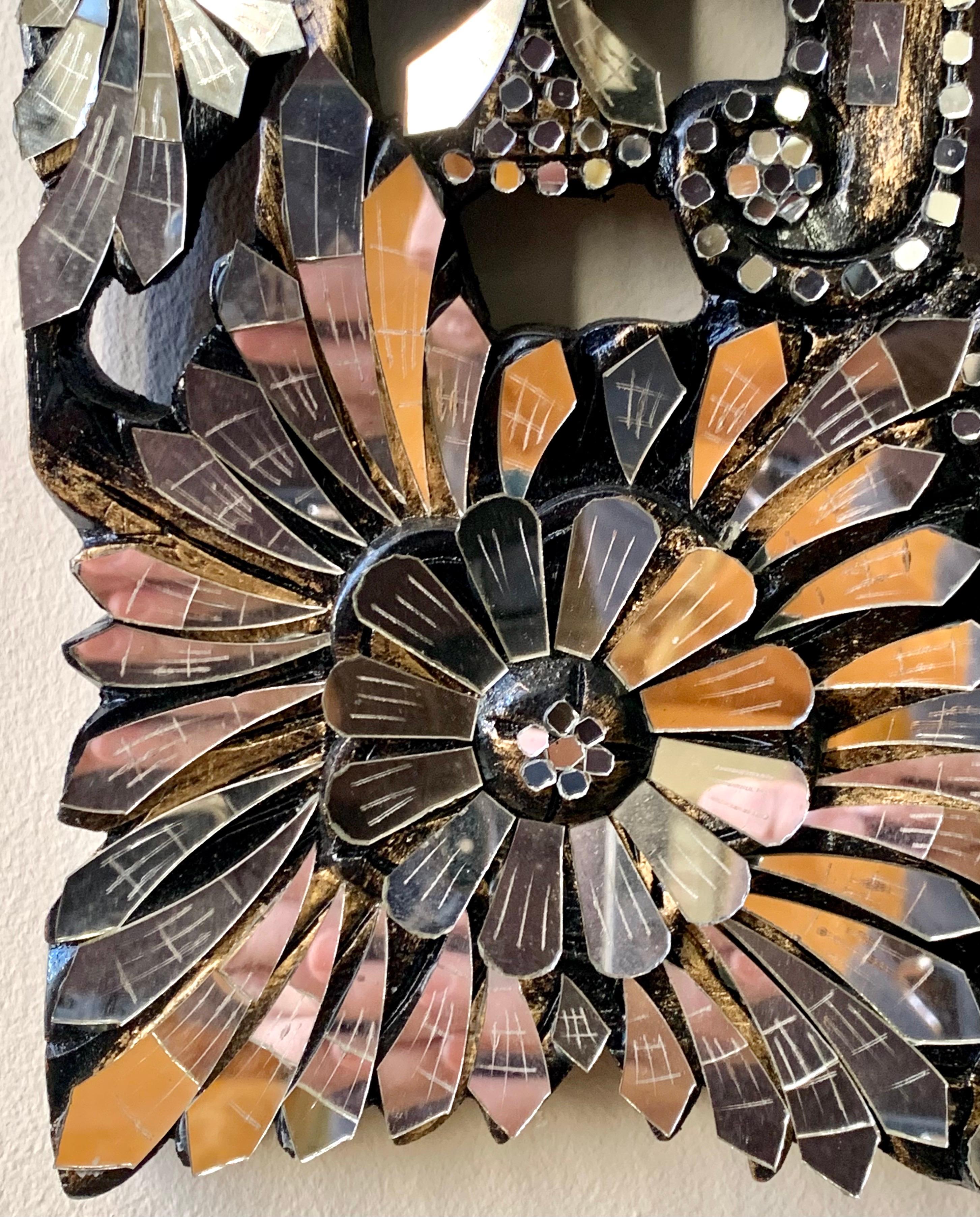 Exquisite Venetian style mirror features a border of flowers made up of layers and layers of mirrored glass. So much prettier in person.
