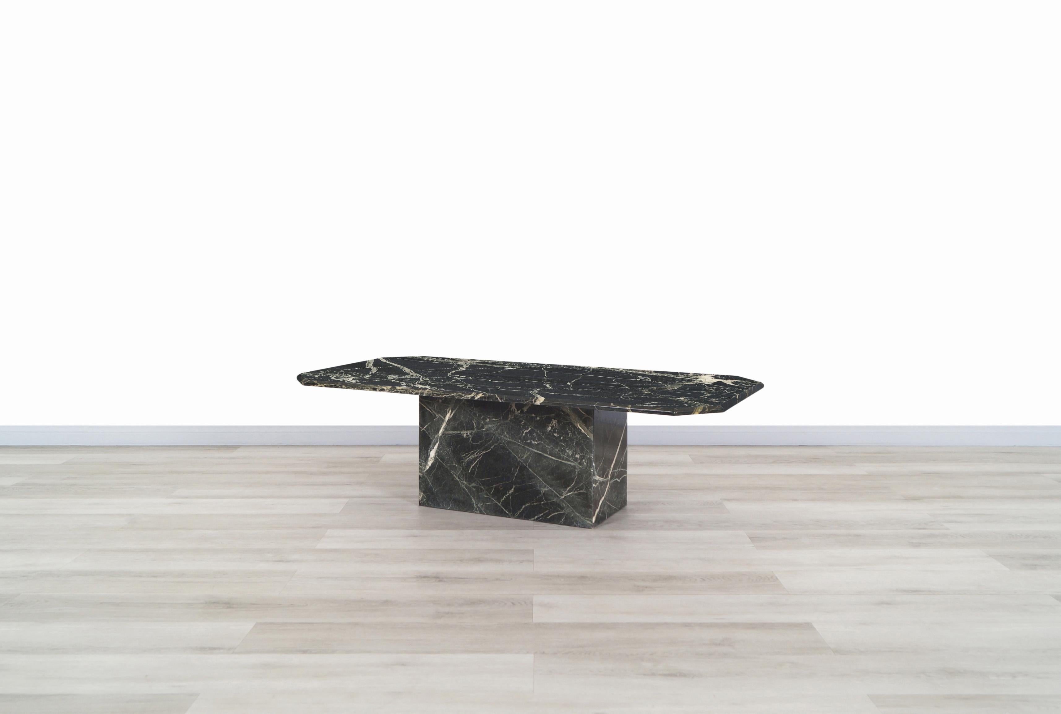 A stunning vintage marble coffee table designed and manufactured in Italy, circa 1980s. This modernist table features a gorgeous verde empress marble that sits over an extremely sturdy base. Simple and Minimalist style along the rich veining and
