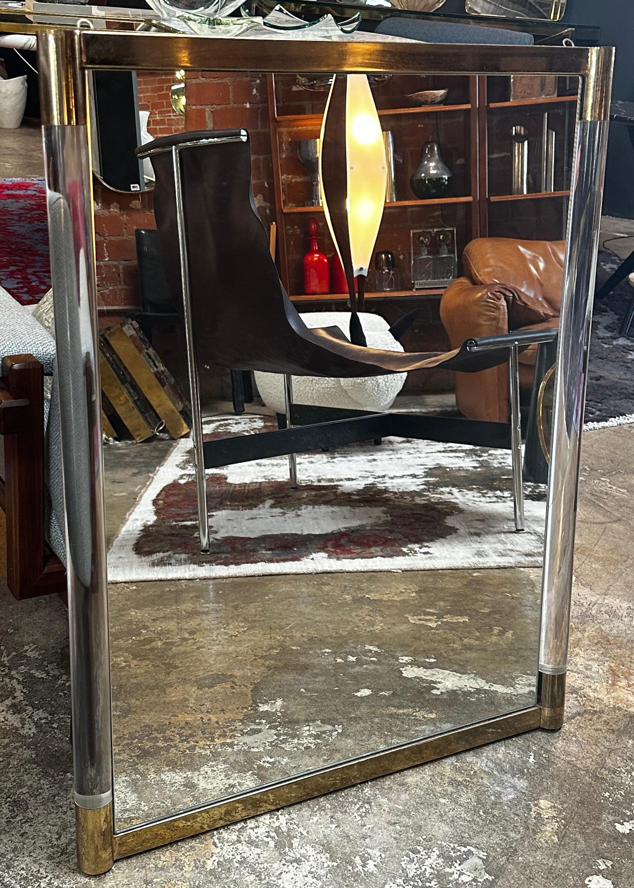 This rectangular wall mirror is a stunning example of modern Italian design. The sleek frame is made of a combination of brass and plexiglass, creating a unique and stylish look that is both contemporary and timeless. The use of plexiglass gives the