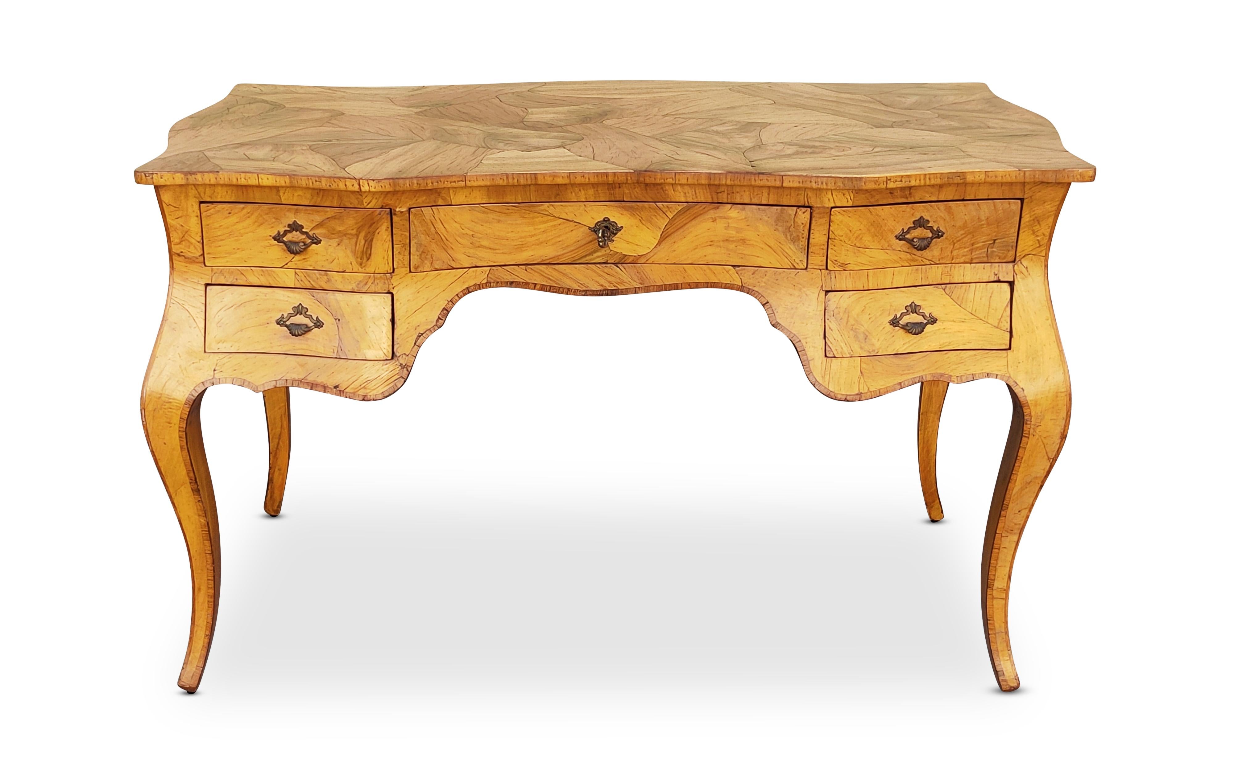 Realizzata a mano in Italia, intorno agli anni '50 o '60, questa splendida scrivania a 5 cassetti in stile Luigi XV o Bombay è realizzata in radica di noce italiana con ferramenta in ottone anticato. Questa scrivania fa parte delle mie collezioni da