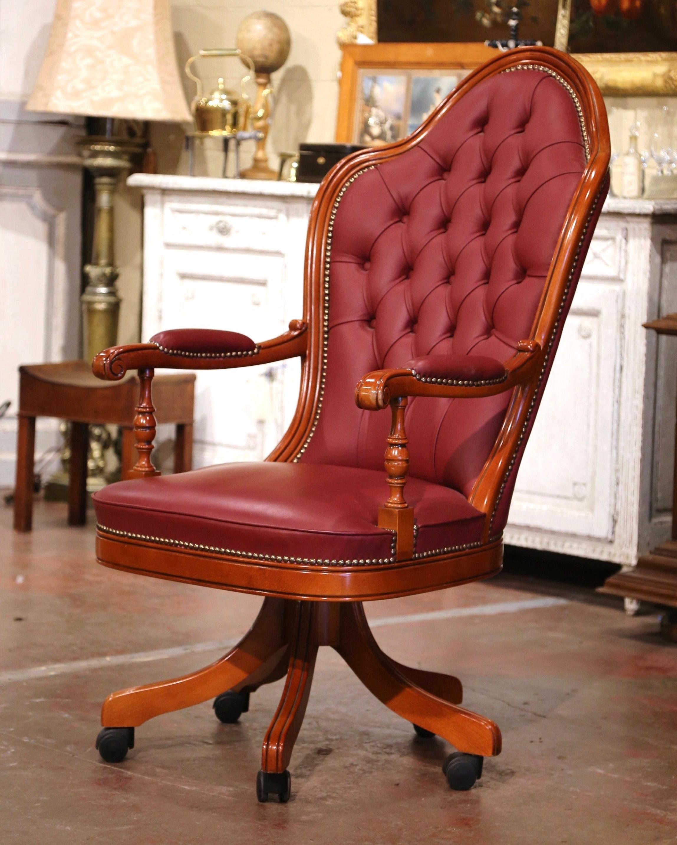 Dress a man's office or study with this elegant vintage armchair. Hand crafted in walnut by Josephine Homes in Italy circa 2000, the chair stands on a swivel base with wooden legs ending in gilt metal casters. The tall fruit wood chair with arched