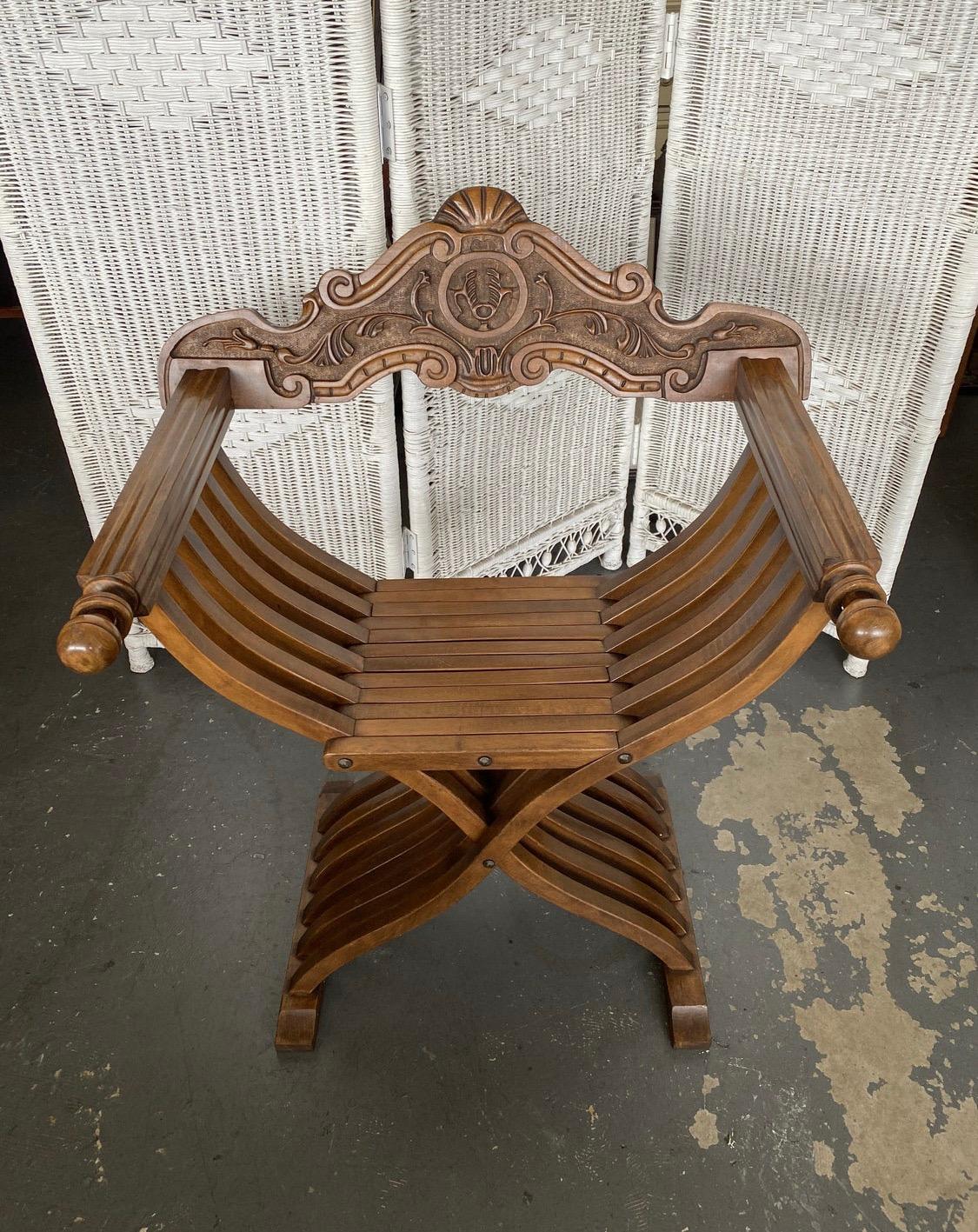 We are offering you a wonderful antique or vintage Savonarola chair in walnut with detailed wood carving on the back piece. This chair will add old world class to your decor in an instant. Don't miss out !

Also know as a Dante chair, x-chair or