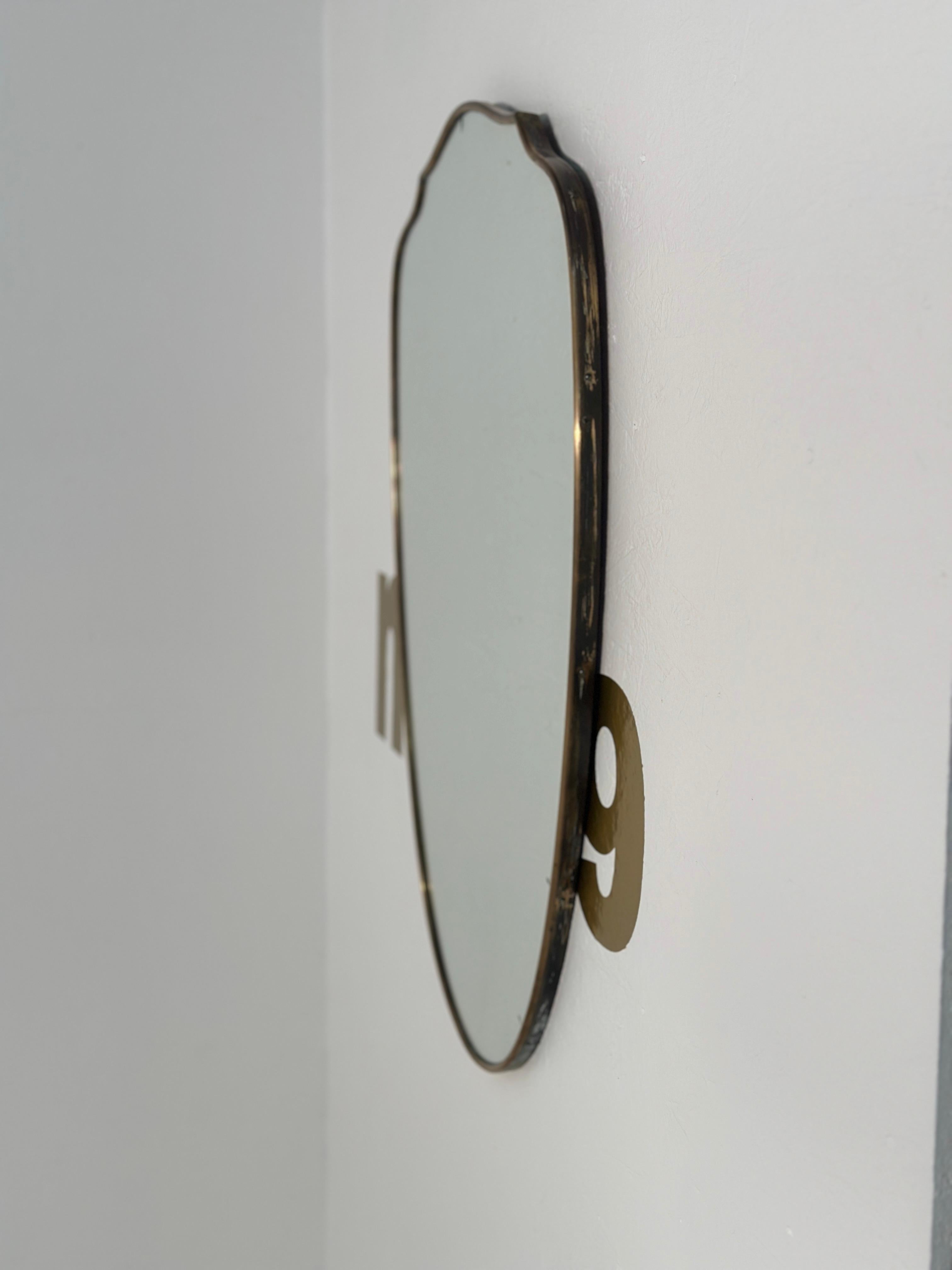 The Vintage Italian Wave Brass Wall Mirror from the 1960s is a stylish piece showcasing the iconic design of mid-century Italy. Crafted from brass with a wave pattern, it adds a touch of sophistication to any room, capturing the essence of vintage