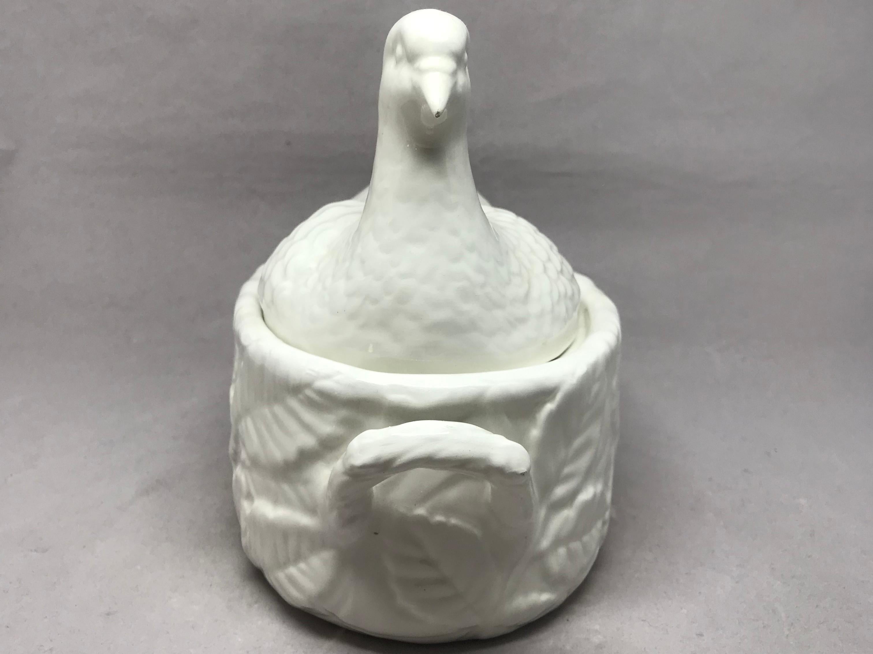 White dove tureen. Small vintage Italian white lidded serving dish in the form of an Easter dove nesting on a foliate handled basket, Italy, circa 1960 
Dimensions: 7.5