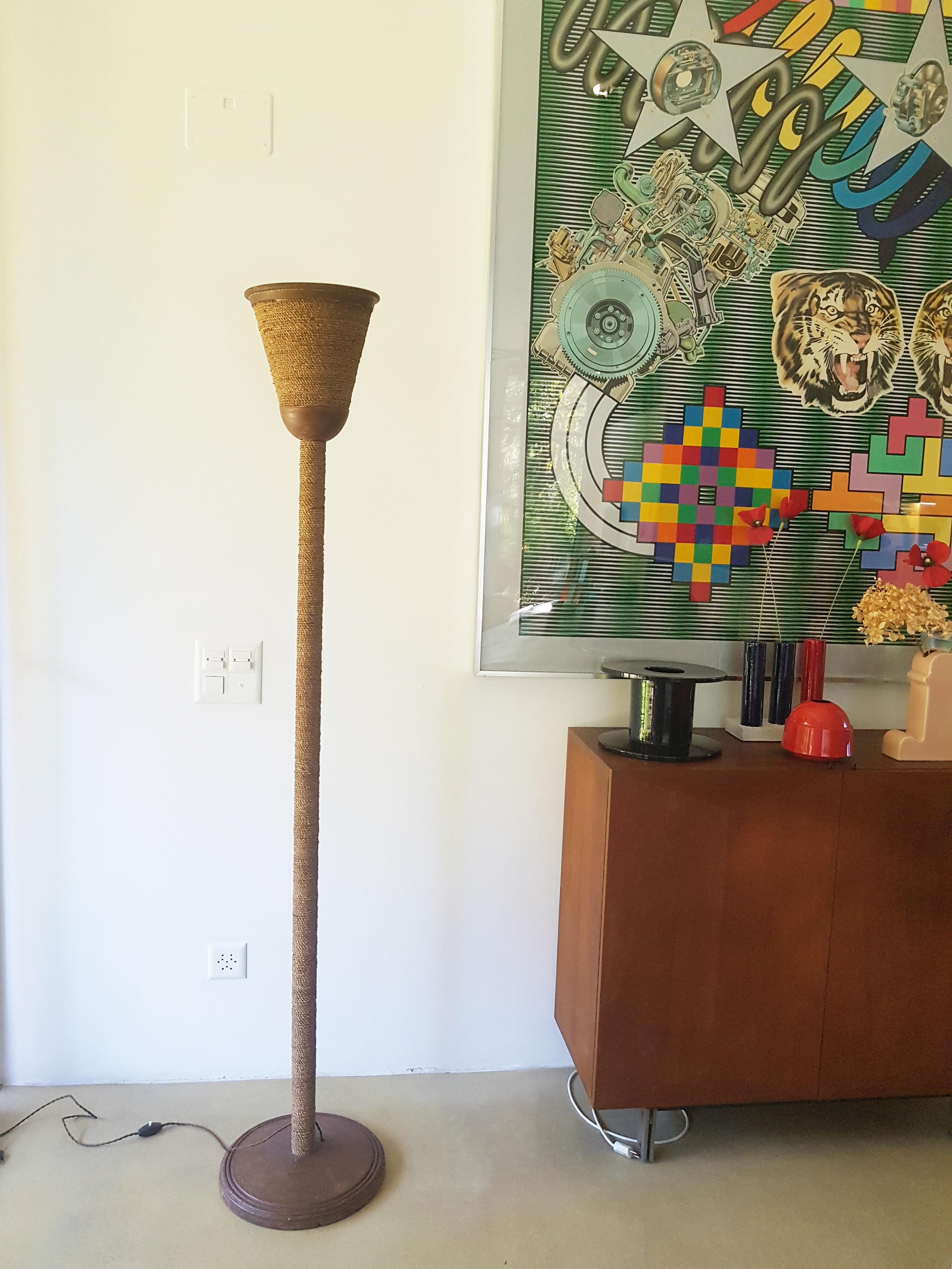 This floor lamp was designed and produced in Italy between the 1930s and 1940s. It is made from wood structure and covered with rope. The lamp has been rewired and remains in working good condition. In some places the rope is less dense than in