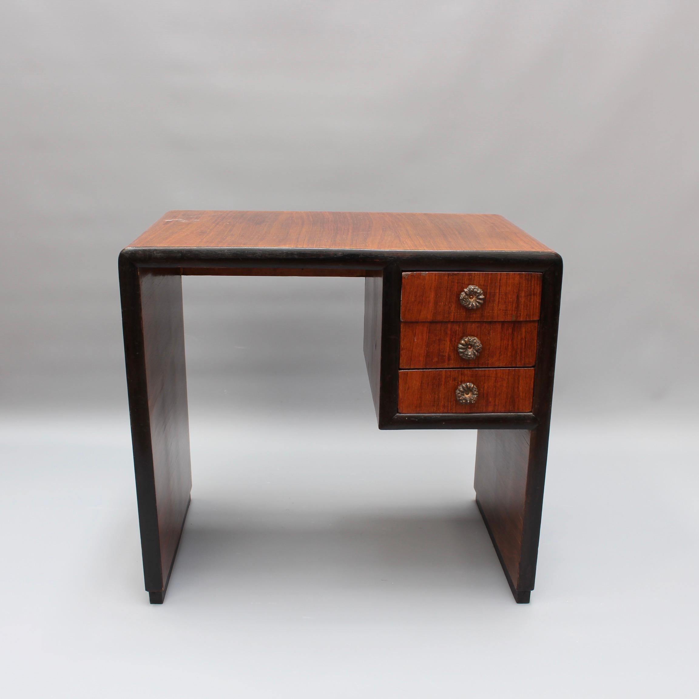 20th century Italian wooden desk, (circa 1970s). A square-edged arched shape with three drawers form the structural outline of this charming wooden desk. Originally custom-created for a small Italian village's boutique Art Deco hotel it has been