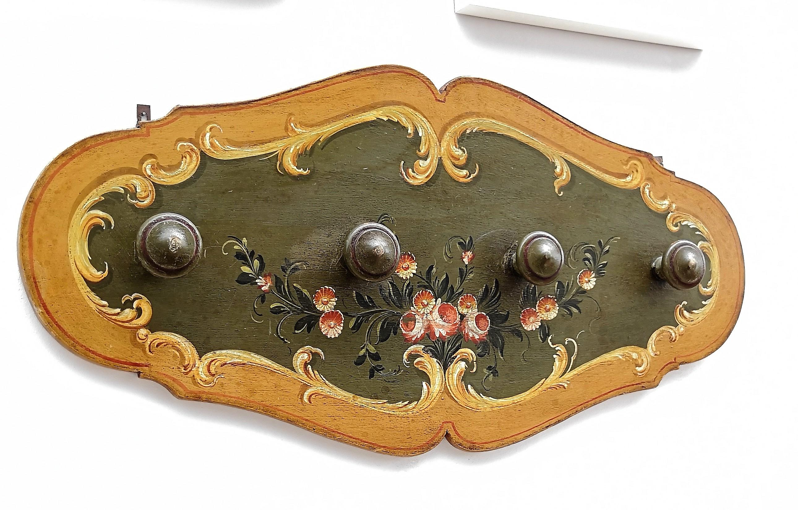 Beautiful vintage Italian wooden coat rack or coat hanger on a hand painted wooden panel with typical mountain or country colors and floral decors, handmade in the surroundings of the Dolomites region around Trento with local woods and crafts.