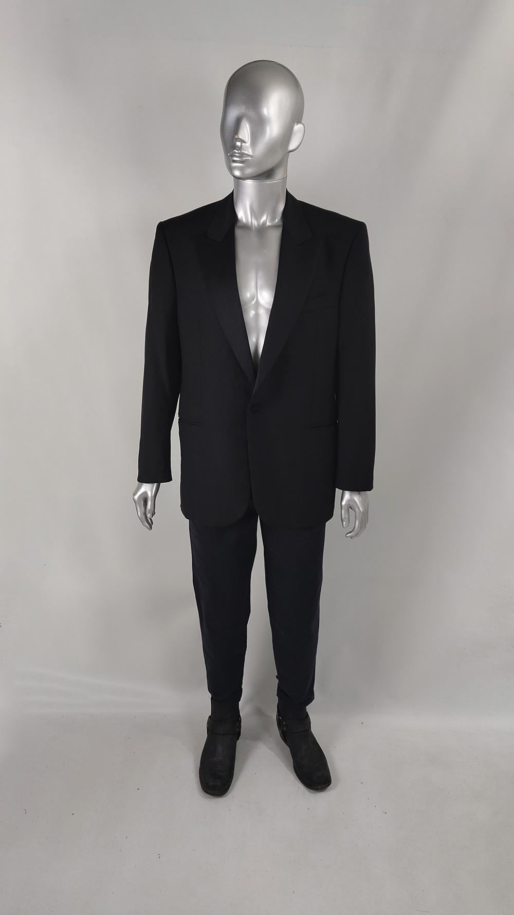 A sleek and stylish vintage mens dinner jacket from the 80s by Italian label, Caesar International. It has matte satin peaked lapels and fastens with a single covered button to the front. Made from a wool and mohair fabric with welt pockets that