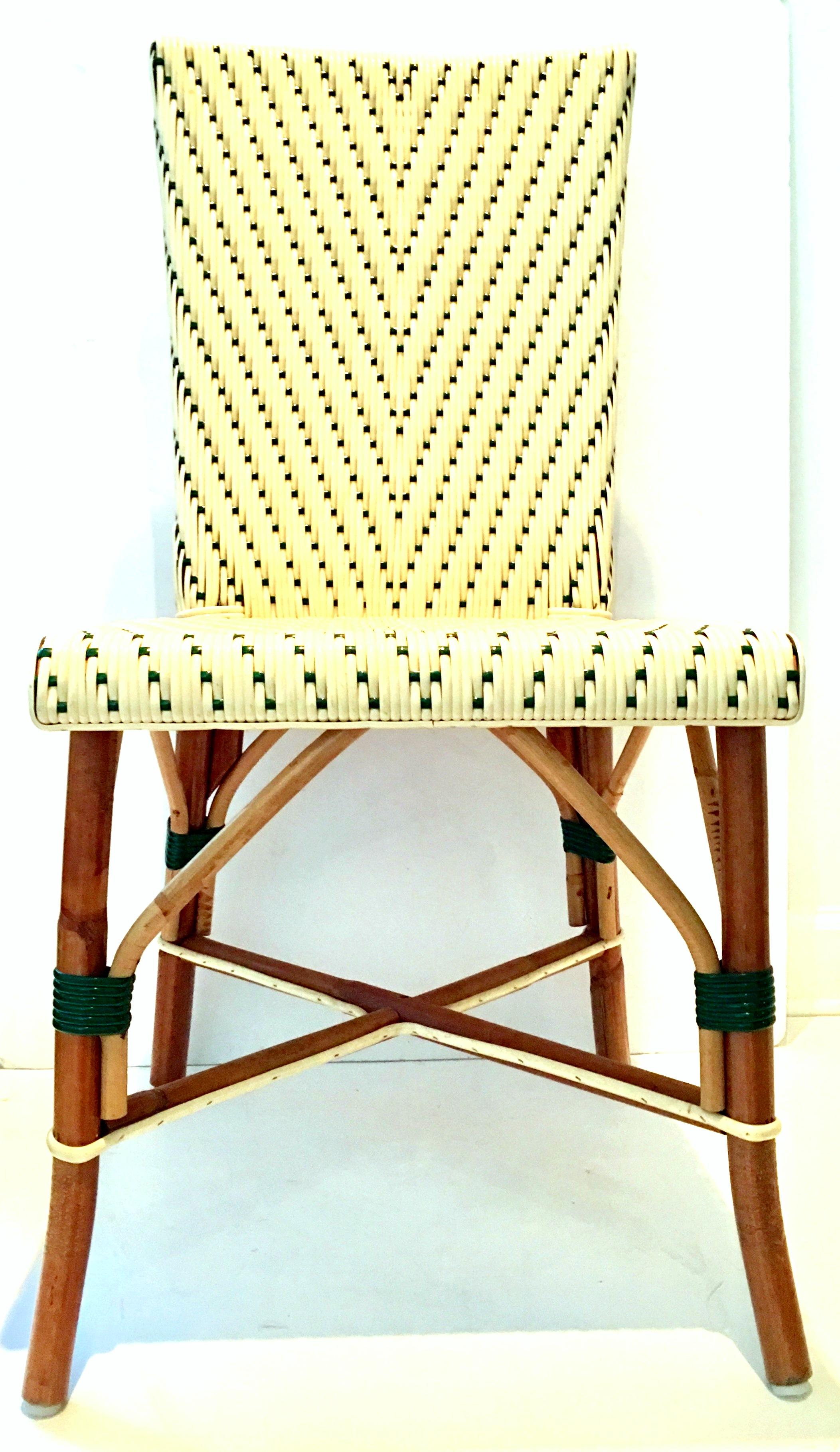 Italian made vintage woven vinyl and rattan Bistro chair. Hunter green and cream colored plastic hand woven with a rattan base. Chair is marked, Made in Italy on the underside. Seat height, 18