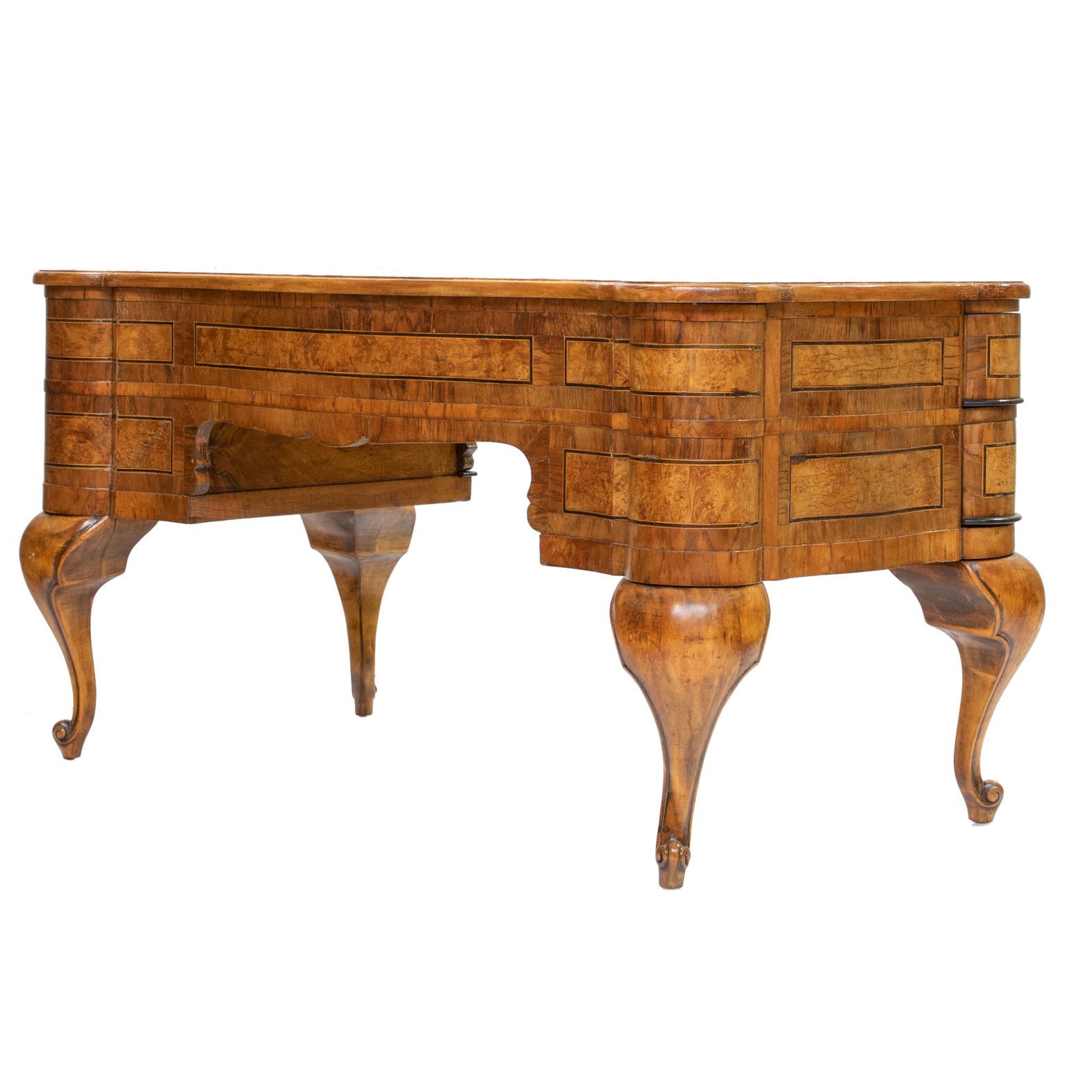 An early 20th century burl walnut writing desk from Italy. Shaped top and front. Shaped drawers (unique).