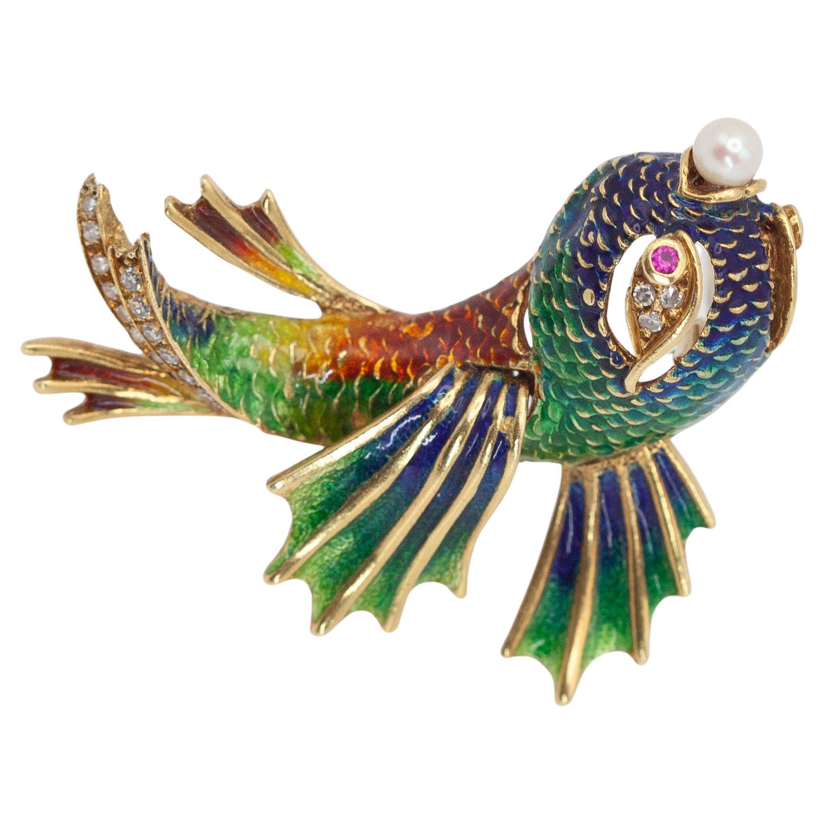 This is a beautifully detailed 18K yellow gold diamond green and blue enamel fish pin brooch set with 21 single cut diamonds 1 round pearl and 2 ruby eyes

Approximate Gross Weight: 20.1 grams 

Approximate Measurement:
48.3mm x 36mm

Hallmark: