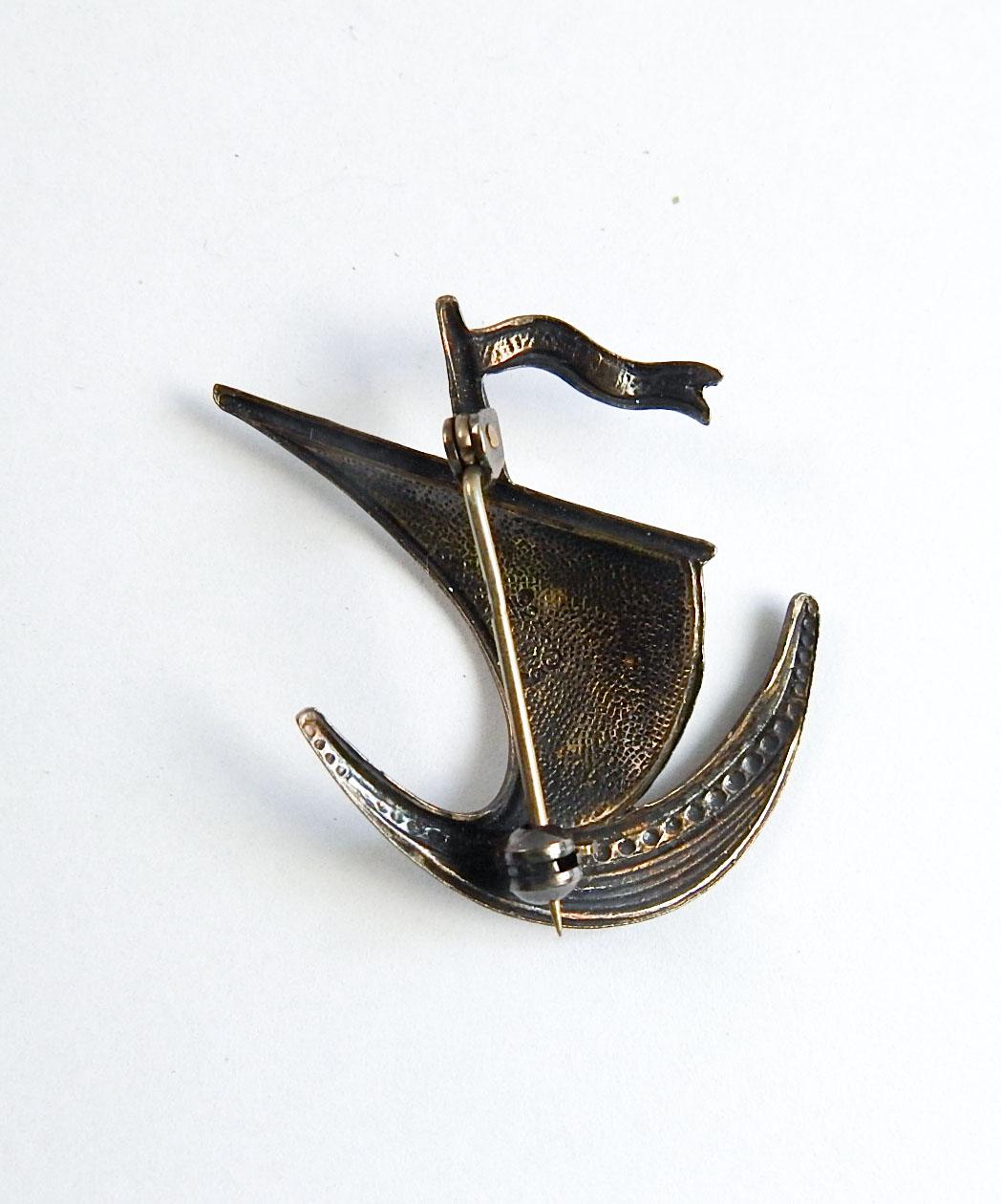 Vintage Ivan Holth, Norway guilloche enamel over sterling silver pin in the shape of a sailing ship. White and blue, marked on back, overall patina to silver, good condition.