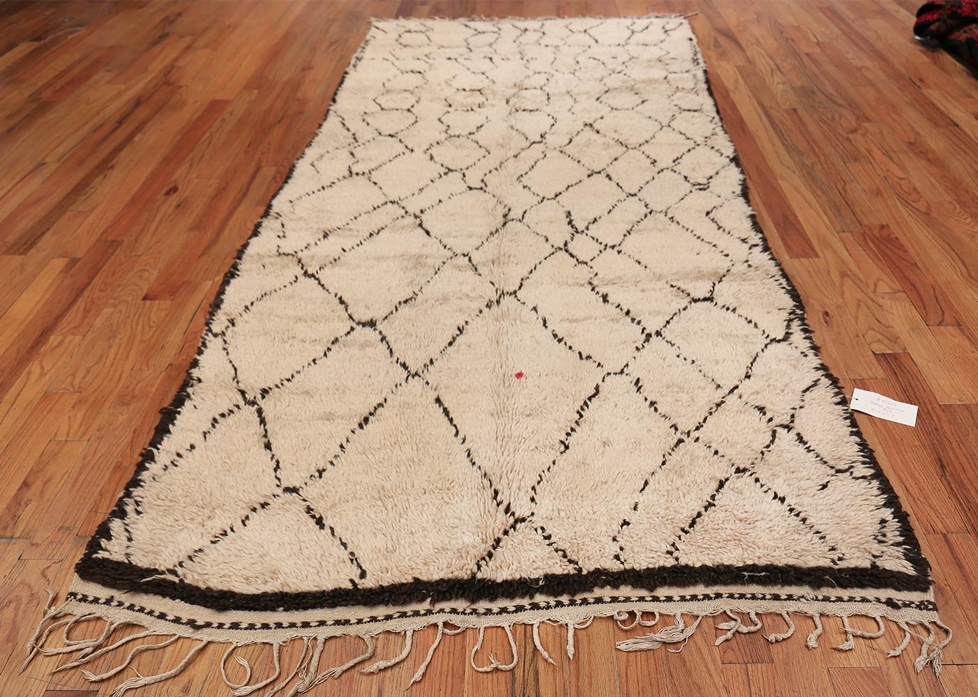 Magnificent Shag Ivory Vintage Beni Ourain Moroccan Rug, Country of Origin / Rug Type: Morocco, Circa Date: Mid – 20th Century. Size: 4 ft 10 in x 11 ft 2 in (1.47 m x 3.4 m)

This fascinating and beautiful Moroccan Beni Ourain rug appears to be
