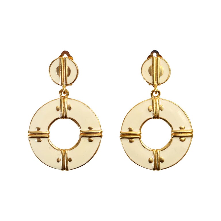Vintage Ivory Enamel and Gold Dangling Hoop Earrings Circa 1980s.  The hoops are front facing and dangle from the round piece so always moving forward. These hoops will always be in style. So chic. Clip On.