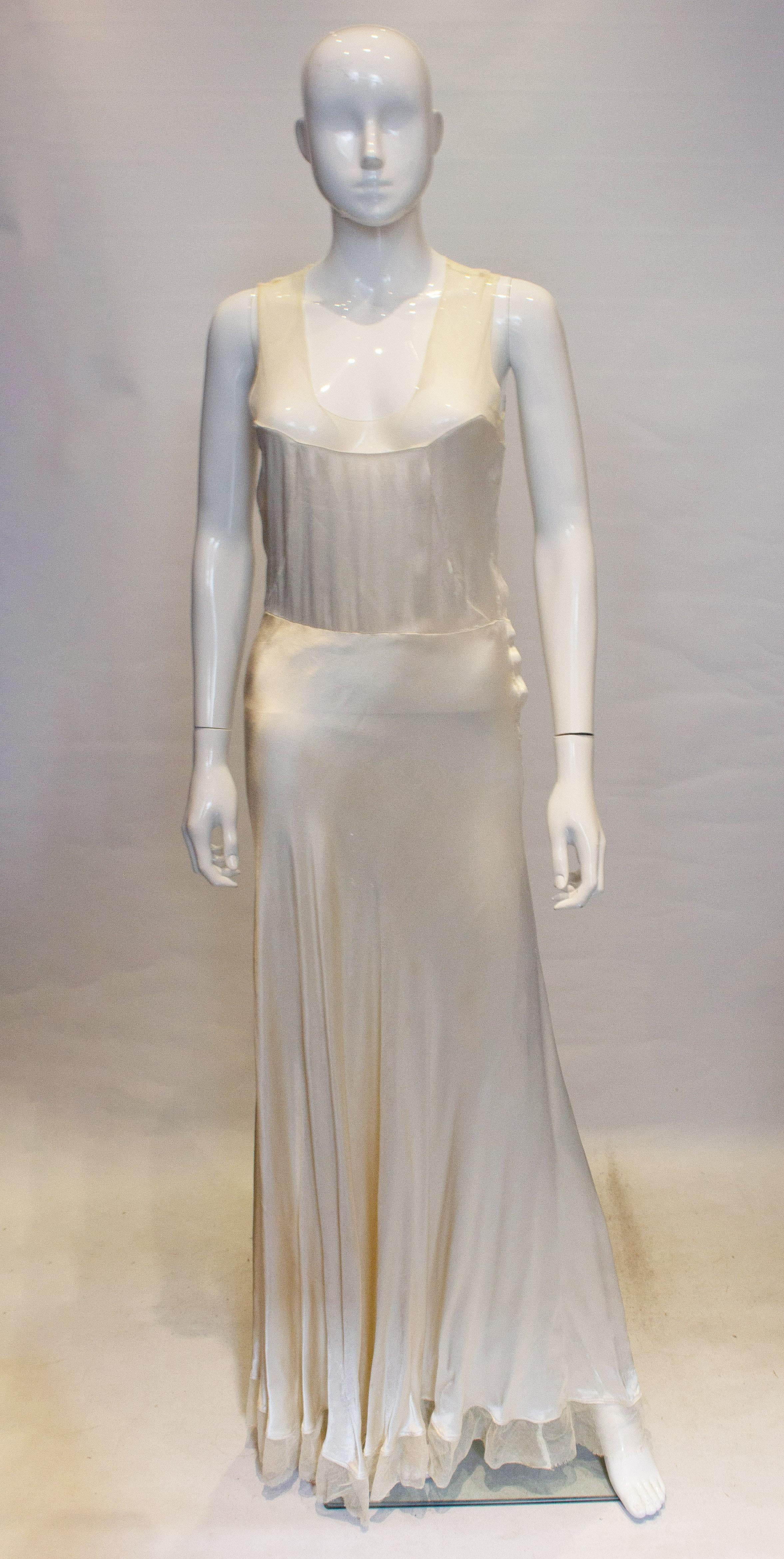 Ein anschmiegsames und leicht zu tragendes Vintage-Slipkleid in einem hübschen Elfenbeinton. Das Kleid hat ein Netzmieder und einen seitlichen Ausschnitt. Maße: Büste 33'', Taille 29'', Länge 65''