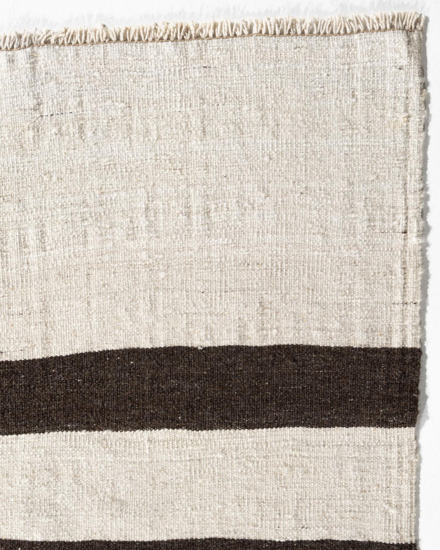 This vintage Turkish flat weave Kilim was hand-woven in the 1940's. The simplicity and boldness of this piece can also give a contemporary feel and is able to look at home in both a modern and traditional setting. The geometric design in soft colors