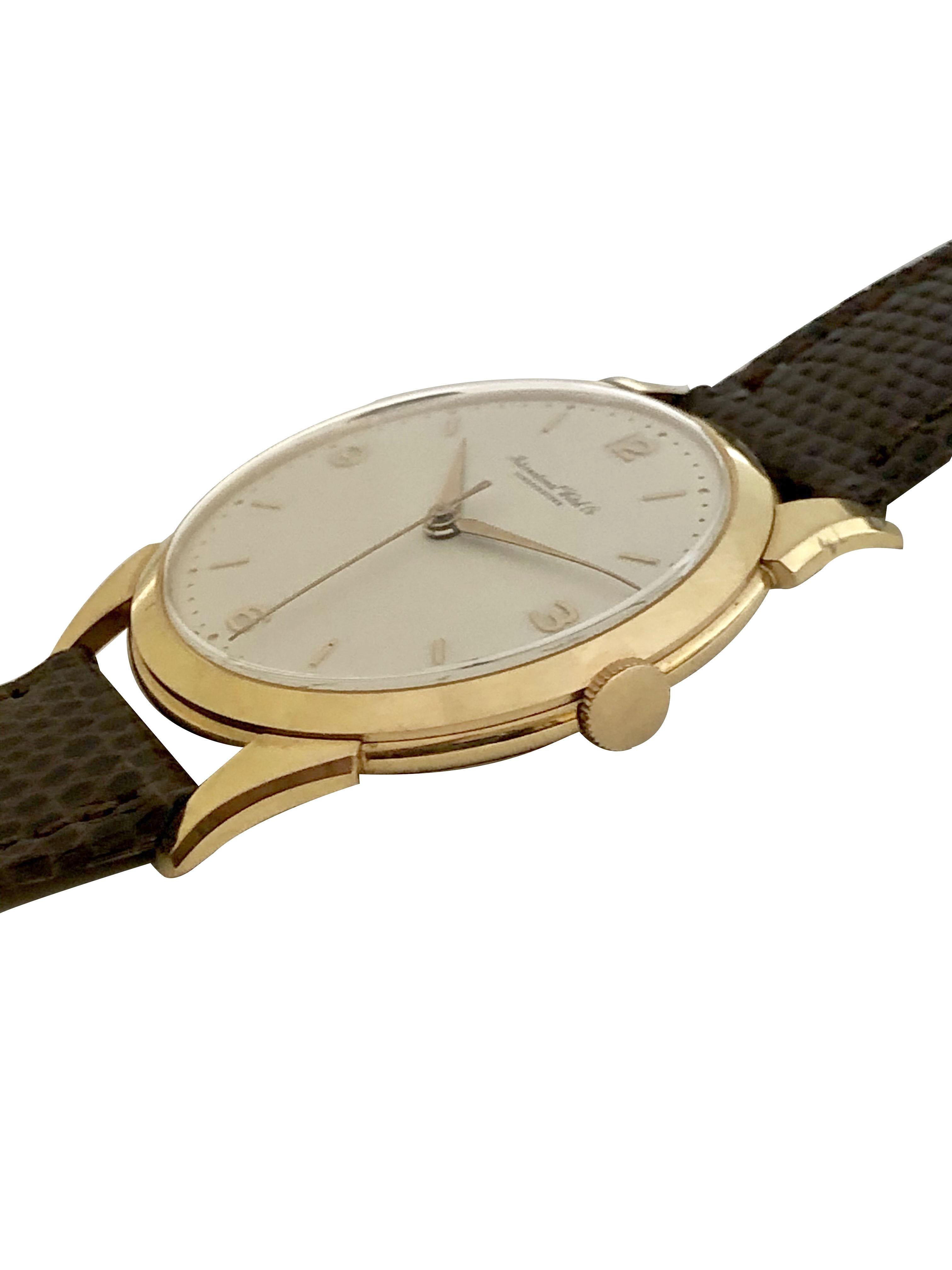 Circa 1950 IWC International Watch Company Wrist Watch, 36 M.M. 3 Piece 18K Yellow Gold Case with Flared lugs. 17 Jewel Nickle Lever mechanical, Manual wind Movement, Original and Mint condition White Matt finished dial with raised Gold markers and