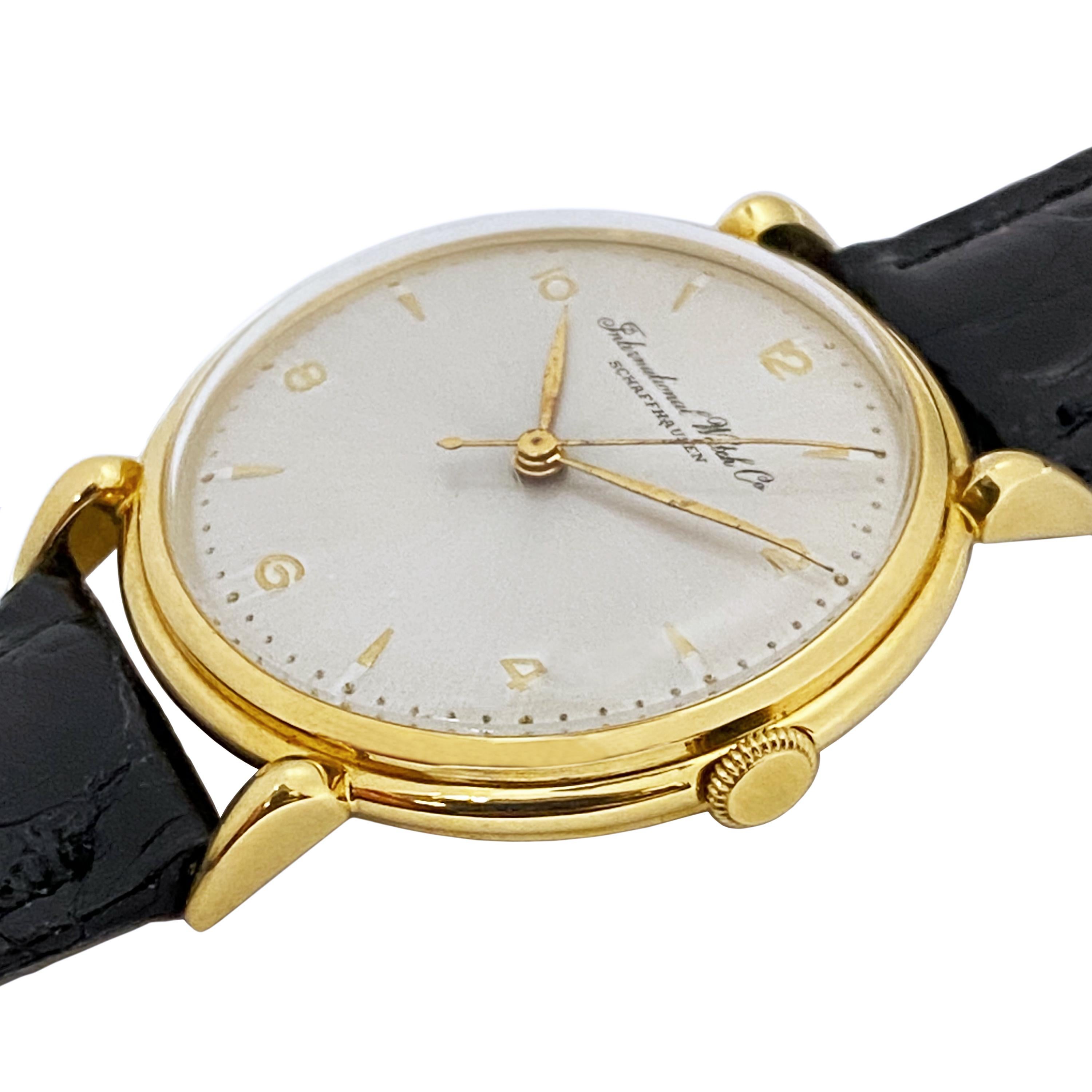 Circa 1950 International Watch Company Schaffhausen Wrist Watch, 36 M.M. 18k Yellow Gold 2 piece stepped case with Horn Rim Lugs. 17 jewel Manual wind movement, Silver satin dial with raised gold markers and a sweep seconds hand. New Black Crocodile