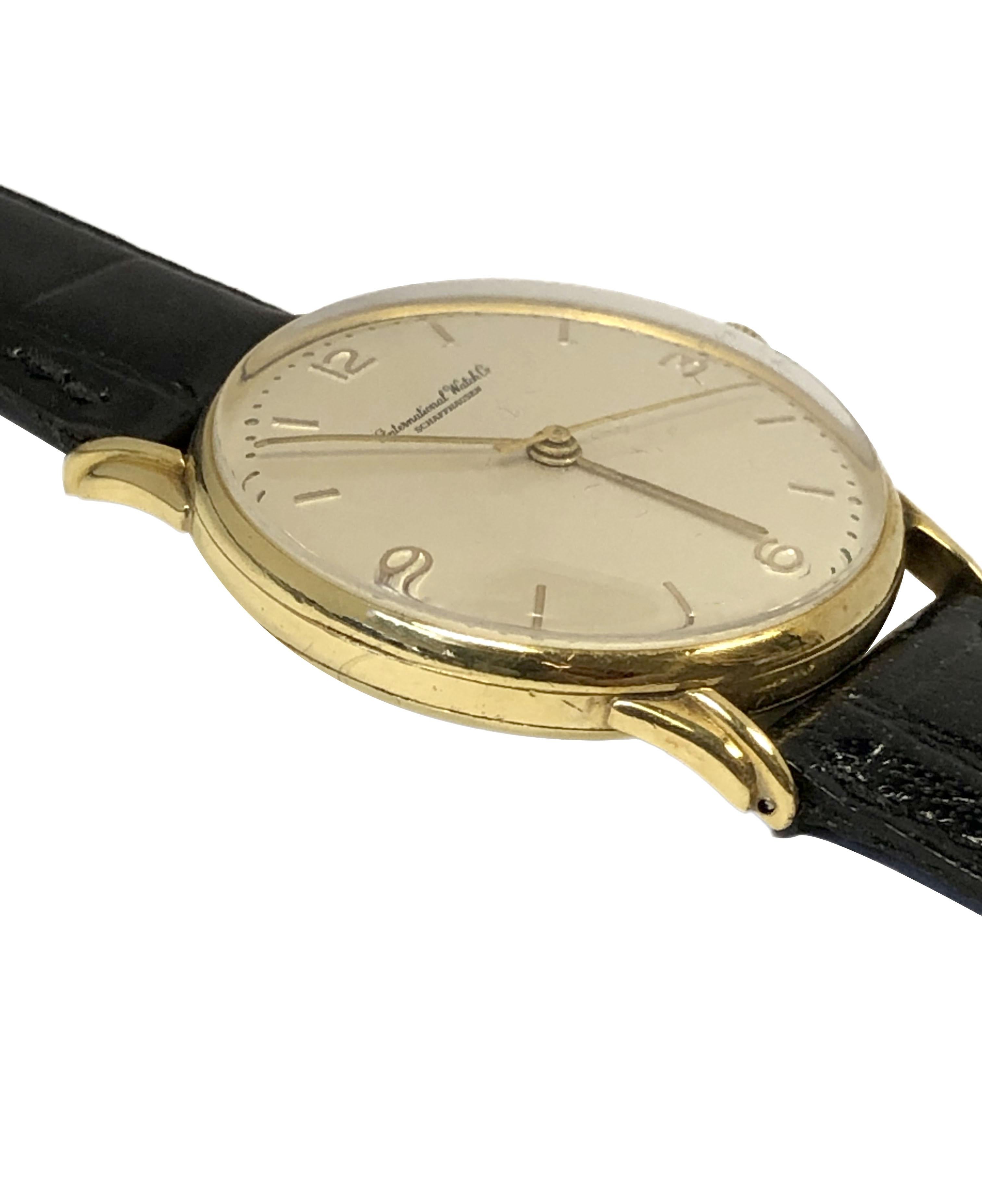 Circa 1950 IWC International Watch Co. Schaffhausen Wrist Watch, 34 M.M. 18k Yellow Gold 3 piece case with fancy stepped lugs. Mechanical, Manual wind movement, original Mint condition Silver Satin dial with raised Gold markers. New Black Croco