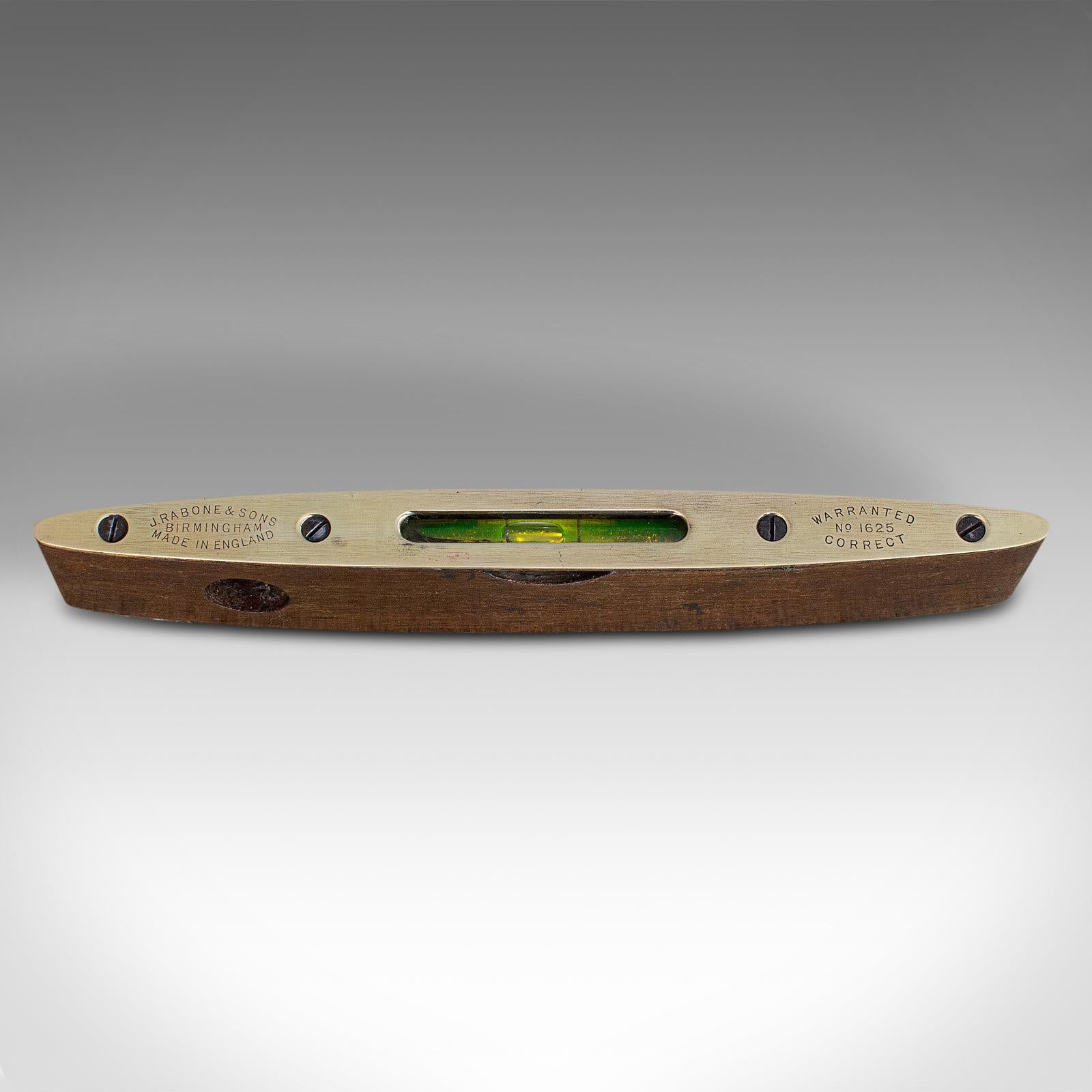 This is a vintage Rabone spirit level. An English, rosewood and brass torpedo level, dating to the mid 20th century, circa 1950.

An attractive mid-century instrument
Displays a desirable aged patina
Rosewood shows Fine grain interest and deep,