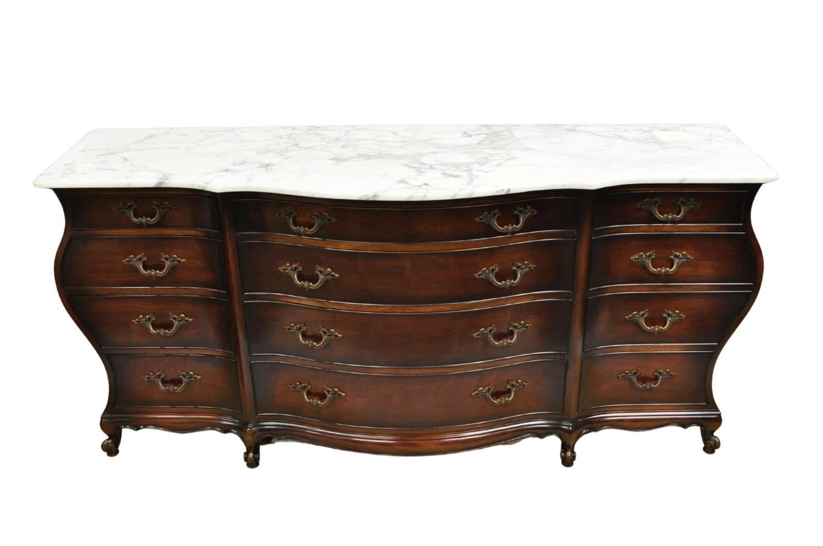 Vintage J. Zonan French Regency Custom Mahogany Marble Top 12 Drawer Bombe Triple Dresser. Item features a serpentine front, shaped marble top, 12 dovetailed drawers, heavy high quality construction, and sleek sculptural form. Circa Mid 20th