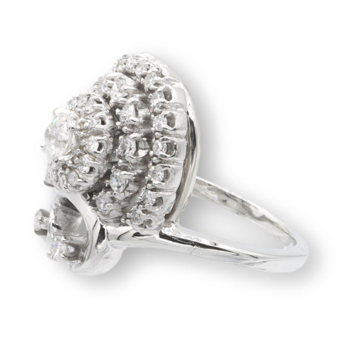Vintage Jabel cocktail ring finely crafted in 14 karat white gold featuring one old european cut center diamond weighing 0.15 carats approximately surrounded by 35 single cut diamonds weighing 0.50 carats approximately, G-H color VS-SI clarity.