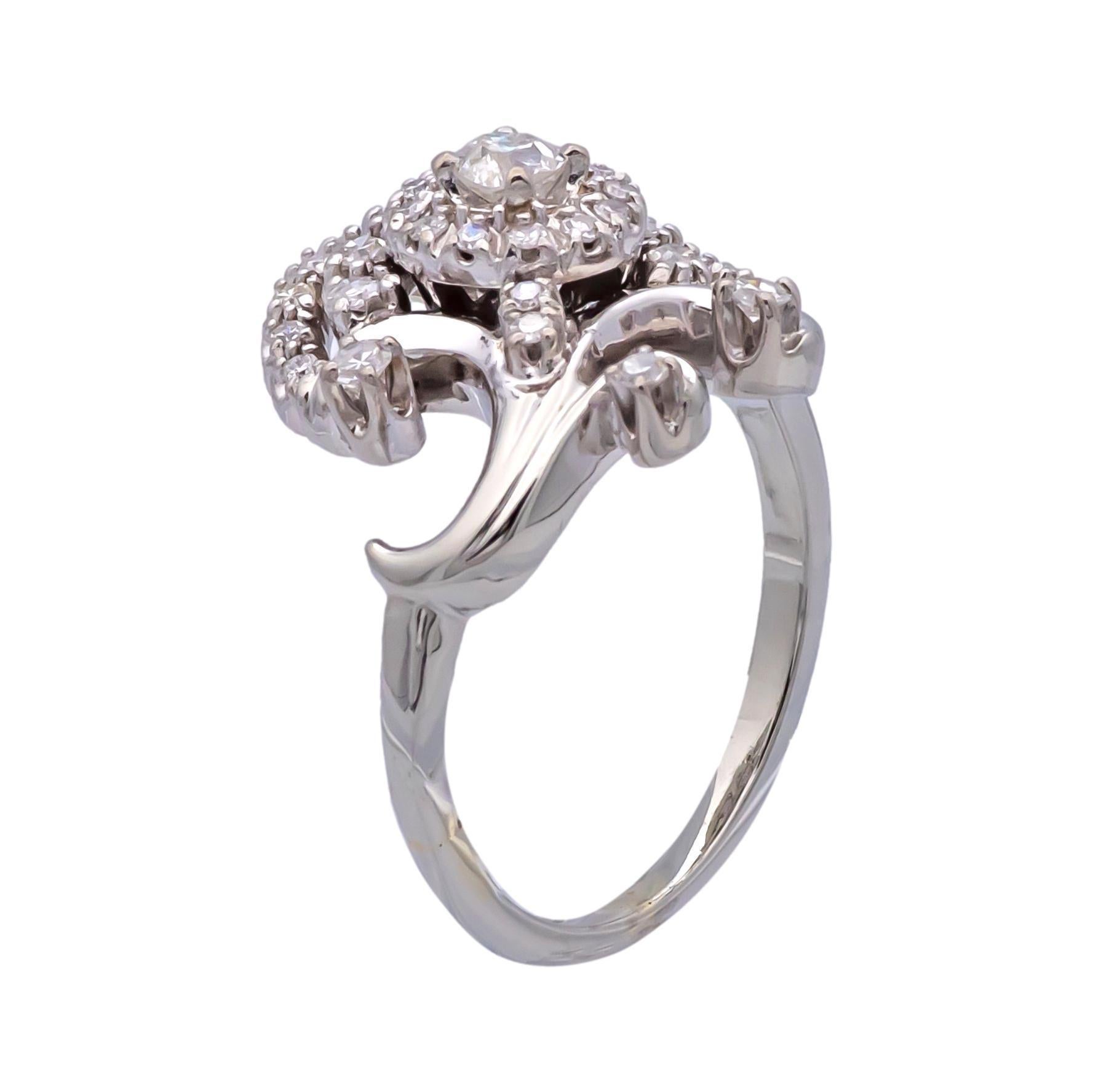 Vintage Jabel cocktail ring finely crafted in 14 karat white gold featuring one old european cut center diamond weighing 0.15 carats approximately surrounded by 35 single cut diamonds weighing 0.50 carats approximately, G-H color VS-SI clarity.