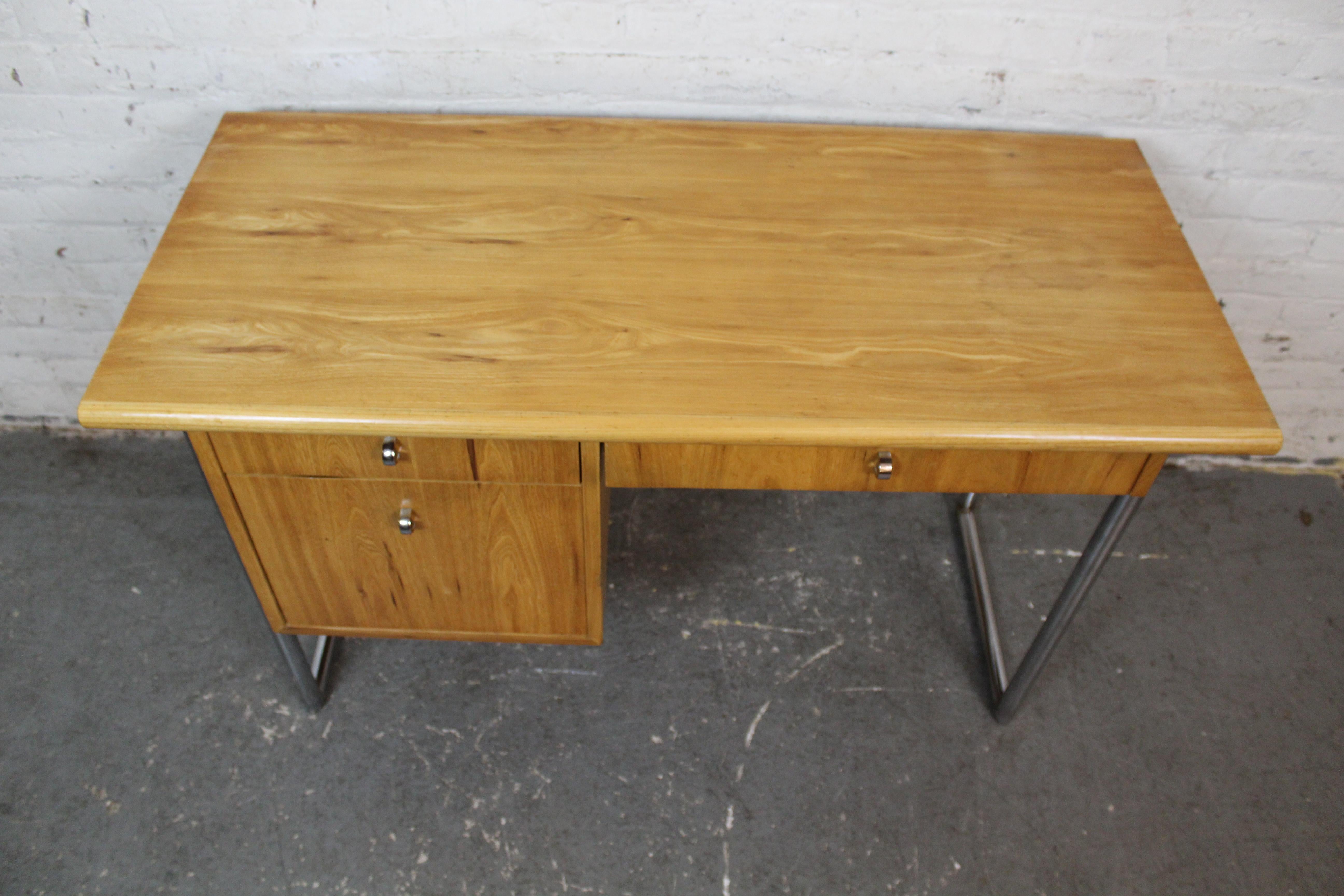 Showing off both Mid-Century Modern and Bauhaus style, this beautiful elm and chrome desk designed by Jack Cartwright packs plenty of functionality into a funky workspace. Made for Founders by the skilled craftsmen of North Carolina’s Thomasville