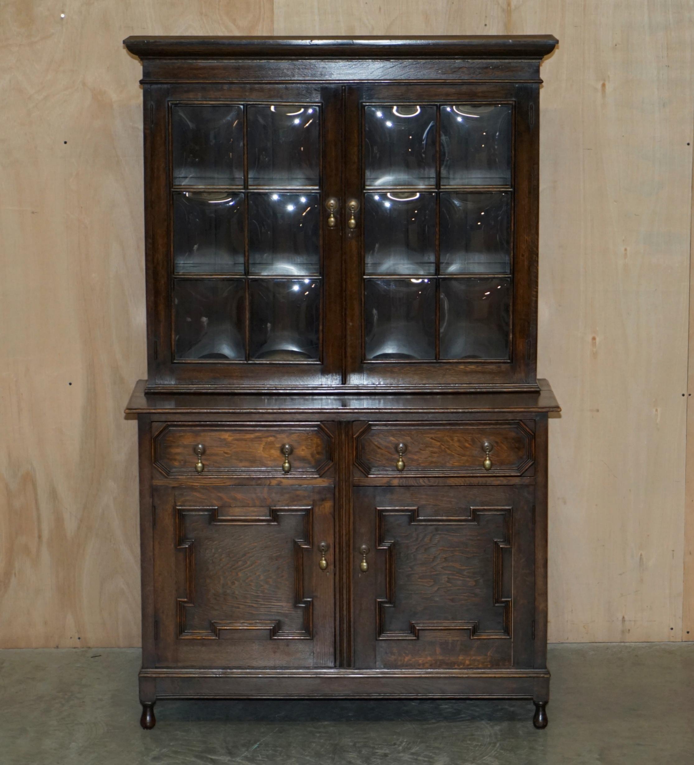 We are delighted to offer for sale this sublime circa 1900 hand carved Jacobean Revival oak library bookcases with beautifully curved glass panes 

A very good looking well made and decorative library bookcase or dresser with stunning bowed glass