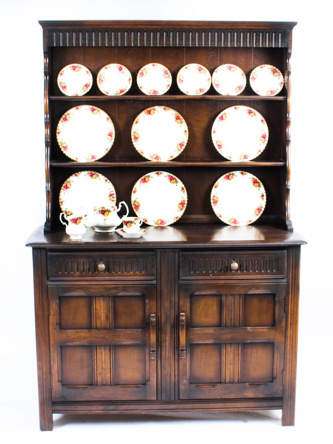 This is a superb Vintage Jacobean revival oak welsh dresser which dates from the second half of the 20th Century.

The top has an open rack with two shelves, the bottom has two capacious drawers over two cupboards with plenty of storage space