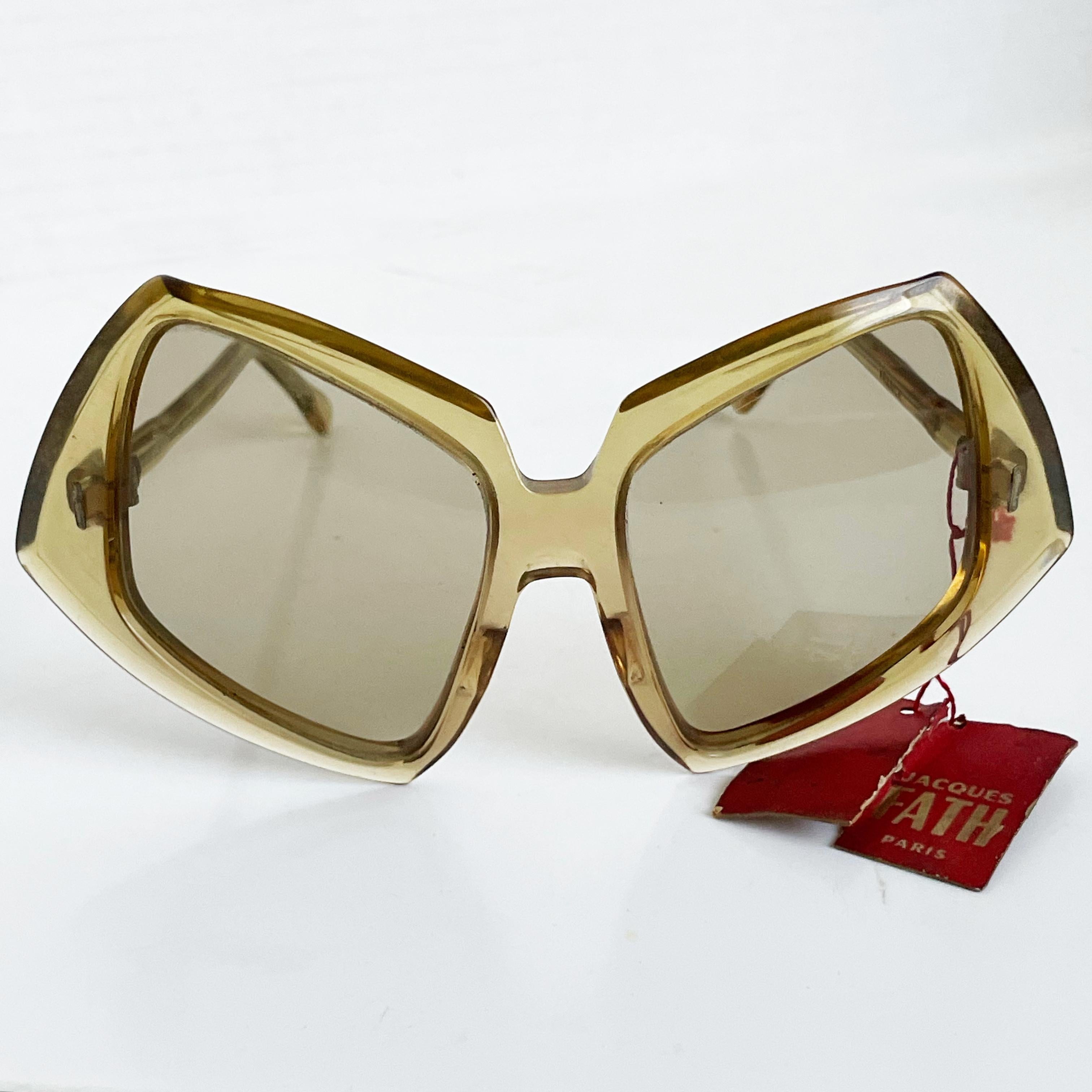 Authentic, vintage sunglasses by Jacques Fath, likely made in the 70s.  Made from resin, these retro mid century style glasses are mod and chic!  They're new old stock and still retain the original store tag, but show some signs of wear from