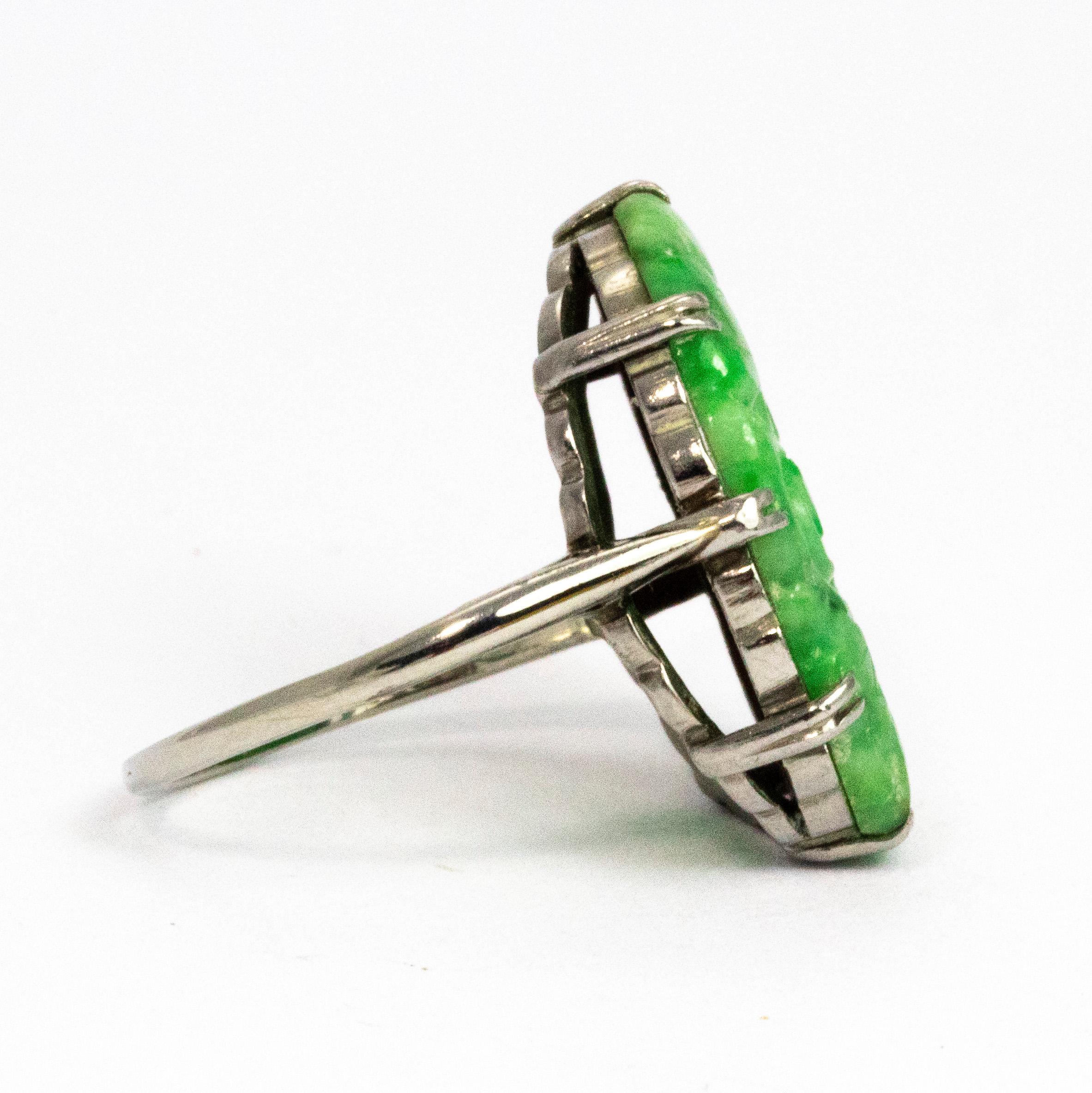 This ring has an Art Deco feel with the style of the engraving and the setting. The jade is beautifully engraved and is held with secure yet delicate double claws all the way around. Modelled in 18ct white gold. 

Ring Size: K 1/2 or 5 1/2
Stone