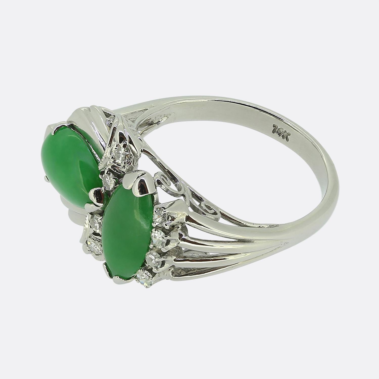 Here we have a unique 14ct white gold ring featuring two cabochon jade gemstones; one pear shaped and the other oval. These focal stones have been interspersed with eight single cut diamonds amidst curvaceous abstract decoration before the piece is