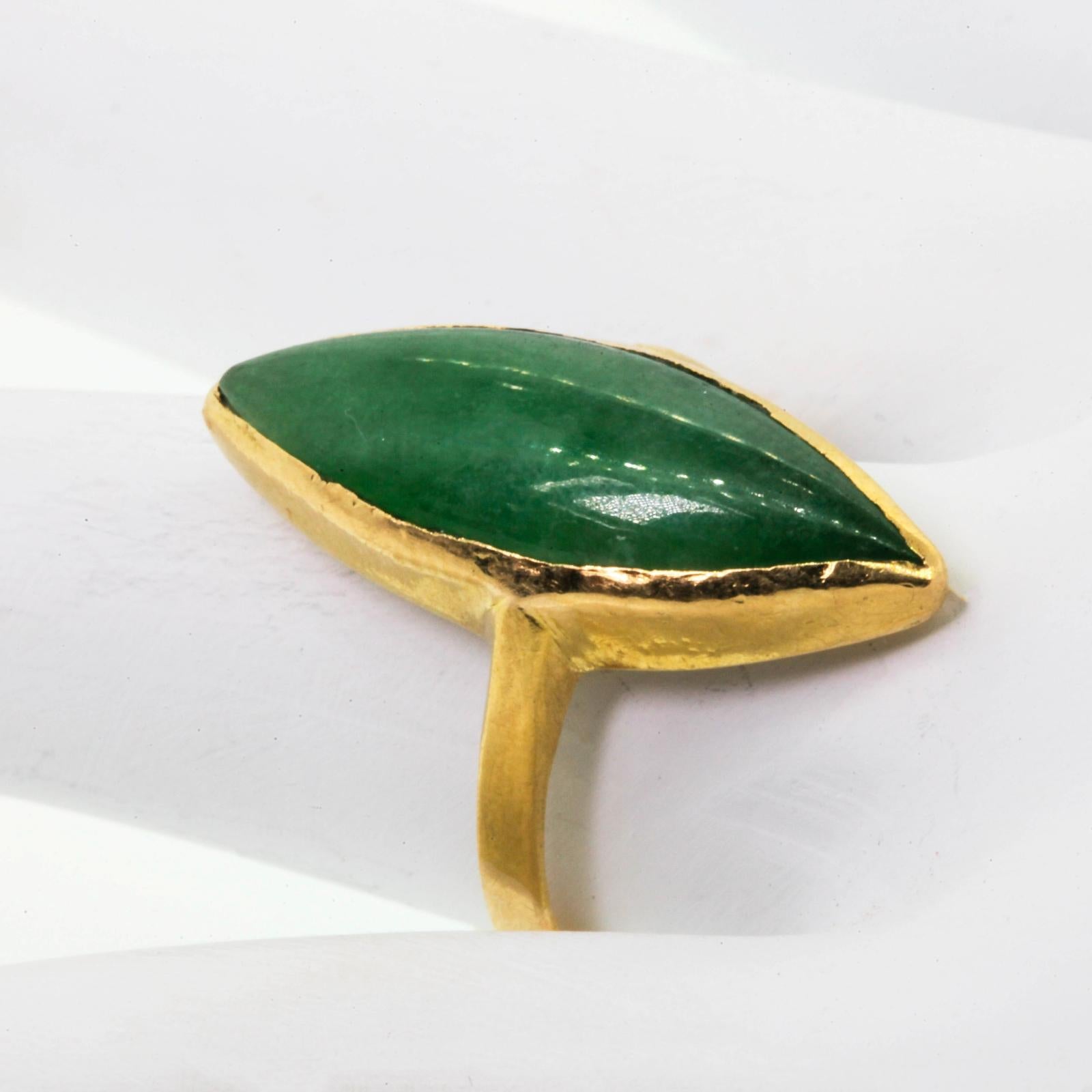 This artisan marquise shape 22KT yellow gold ring,  showcases a cabochon translucent Jadeite stone.  The ring is stamped with Chinese characters  and is gently time worn.  Ring size 7 3/4.  Circa 1970s