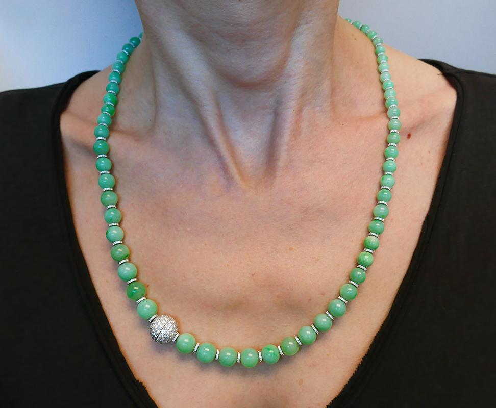 Timeless natural jade necklace with alternating diamond & 14 karat white gold rondelles and pave-set diamond clasp. Seventy-four translucent light green untreated jade beads are graduating from 9.3 x 8.7 mm to 4.7 x 4.6 mm. Diamonds are I-J color,