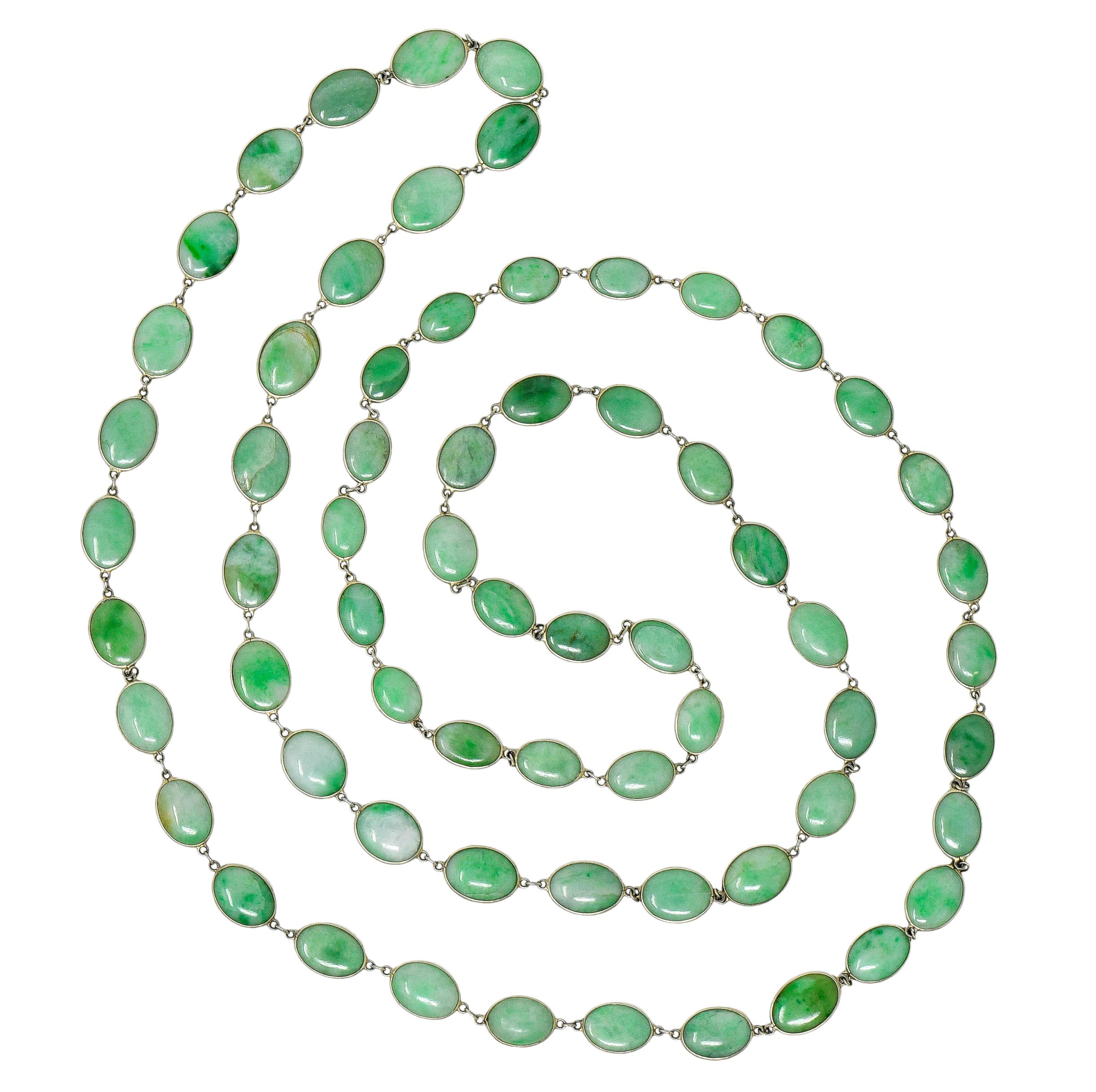 Eternity style necklace is comprised of oval jade cabochon, double sided with slim profile height

Bezel set in white gold and graduating in size from 11.0 x 8.0 mm to 14.0 x 10.0 mm

Translucent with dark green to very light green mottled color,