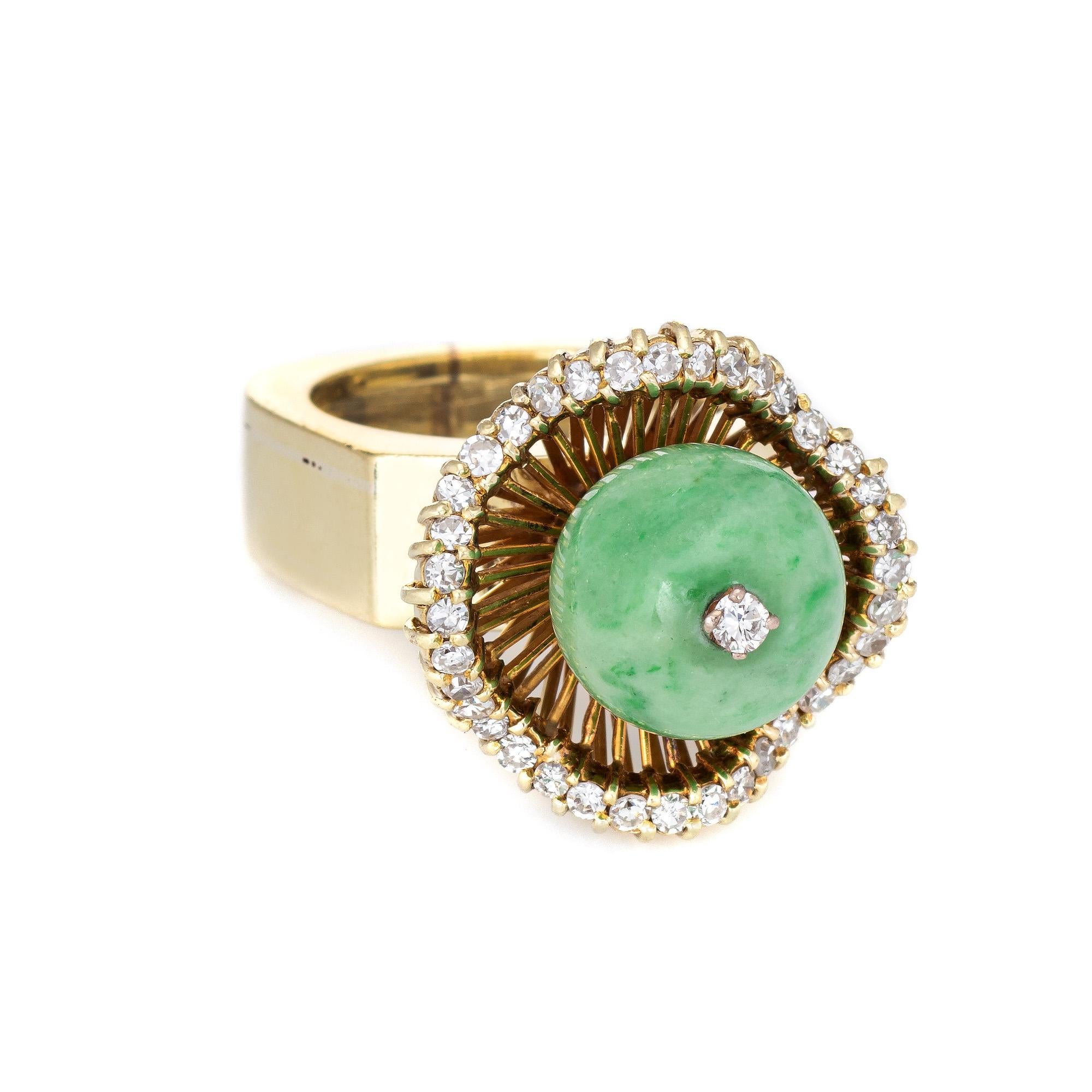 Stylish vintage jade & diamond cocktail ring (circa 1960s) crafted in 14 karat yellow gold. 

Jade measures 11.5mm, accented with an estimated 0.55 carats of diamonds (estimated at H-I color and VS2-SI1 clarity). The jade is in excellent condition