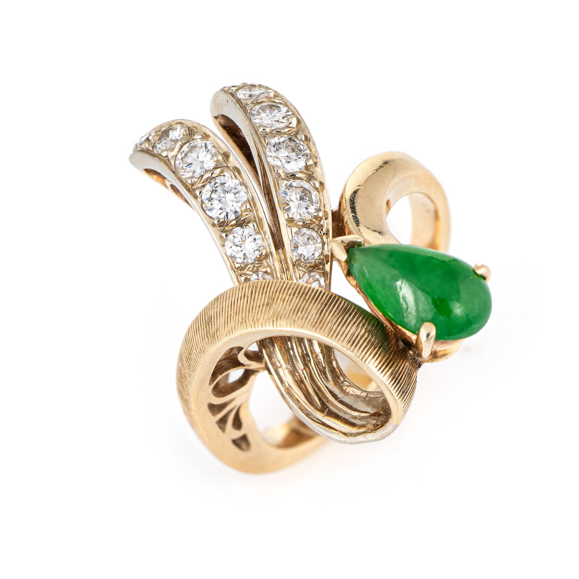 Stylish vintage jade & diamond cocktail ring (circa 1960s to 1970s) crafted in 14 karat yellow gold. 

Cabochon cut pear shaped jade measures 8mm x 4mm (estimated at 0.50 carats), accented with an estimated 0.22 carat of diamonds (estimated at H-I