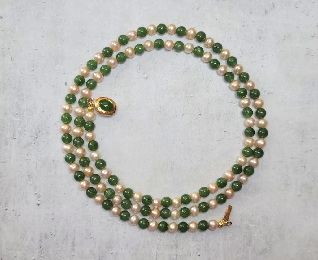 Introducing a classic necklace of exquisite natural freshwater pearls and premium quality natural green nephrite.

The length of the necklace is 30 inches (76 cm).
The size of the smooth round nephrite beads is 6 mm, and the size of the freshwater