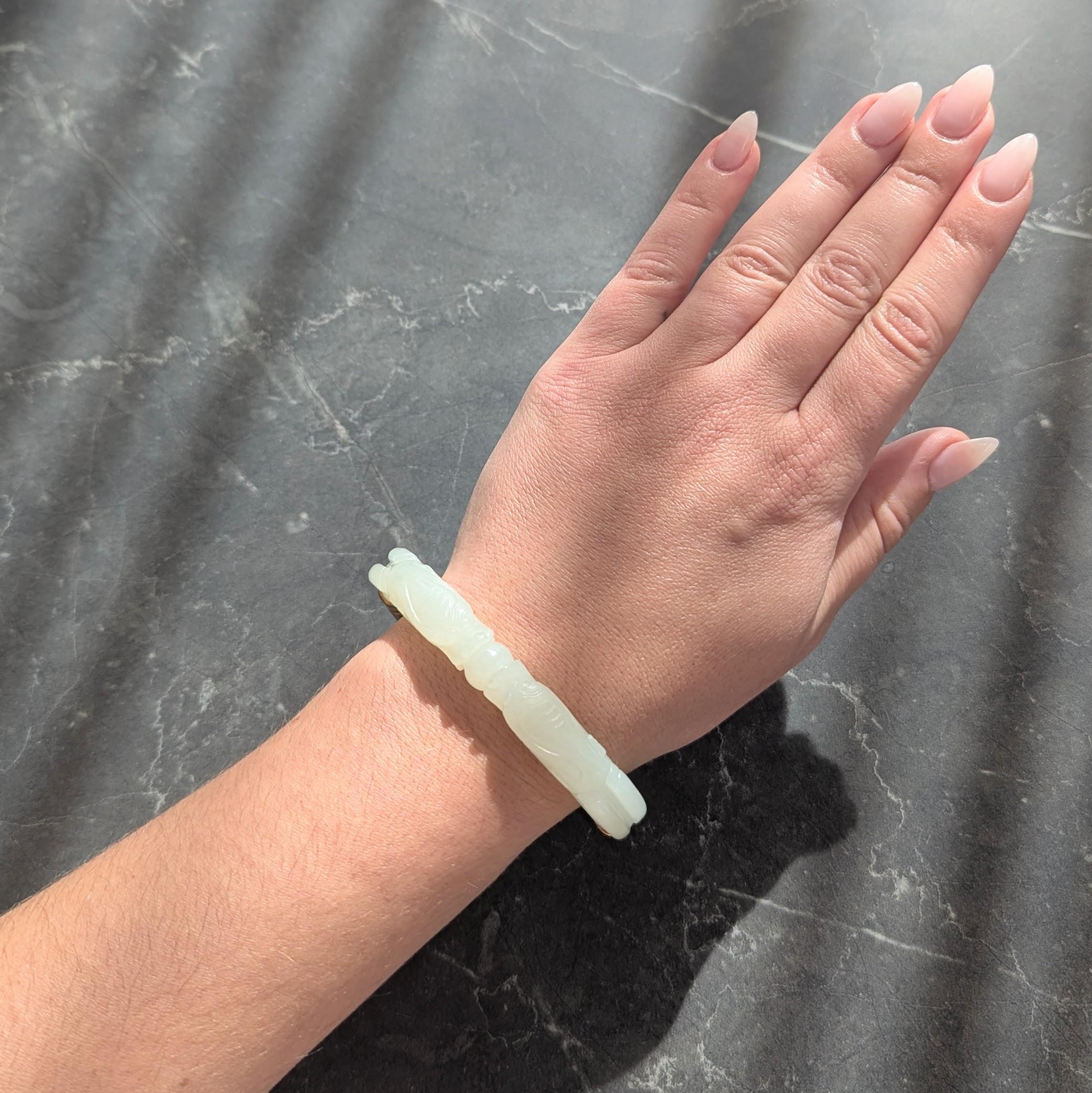 Designed as a bangle style bracelet featuring a carved jade top-half
Depicting the Chinese myth, two dragons playing with pearl
Symbolic of prosperity, strength, wisdom, and respect for life
Translucent light pastel green in color with carved