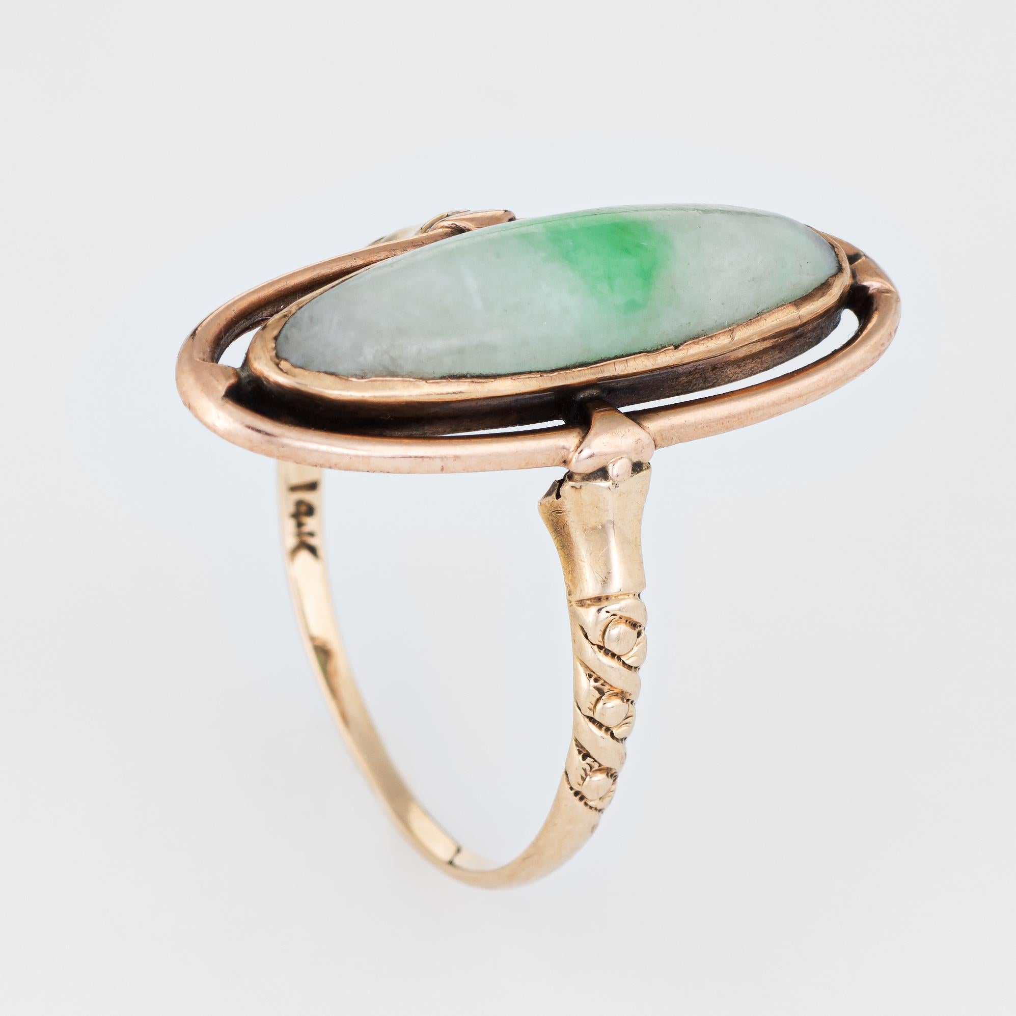 Finely detailed vintage jade ring (circa 1940s to 1950s), crafted in 14 karat yellow gold. 

Jade is cabochon cut measuring 20mm x 6mm (estimated at 4.50 carats). The jade is in excellent condition and free of cracks or chips. 

The stylish vintage