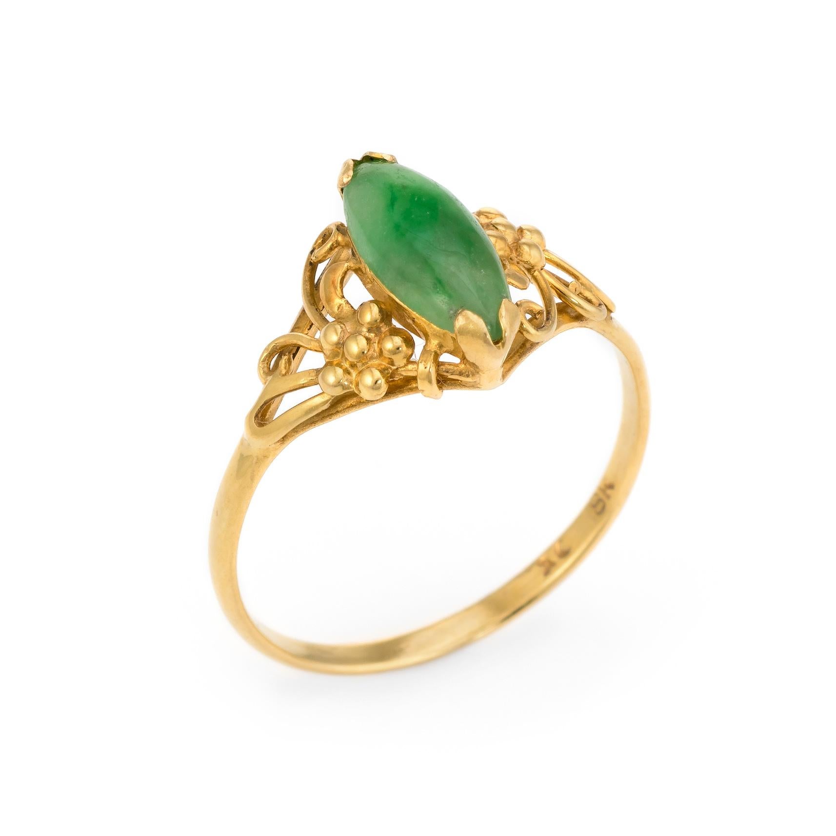 Finely detailed jadeite jade small cocktail ring (circa 1950s to 1960s), crafted in 18 karat yellow gold. 

Jadeite is cut en cabochon, measuring 10mm x 4mm (estimated at 0.75 carats). The jade is in excellent condition and free of cracks or chips. 