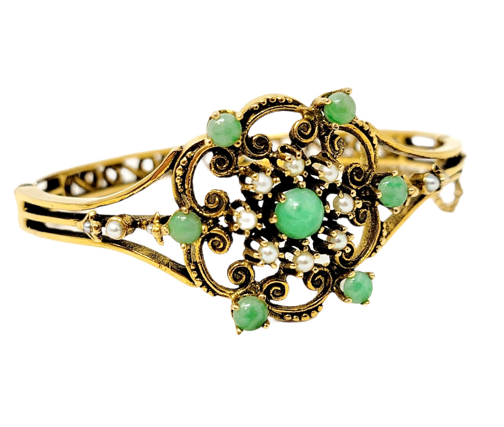 Gorgeous vintage bracelet with stunning ornate details. Delicate in design yet bold in beauty, this vintage bangle will truly light up your wrist. This lovely bracelet features a single .87 carat round cabochon jadeite stone prong set at the center