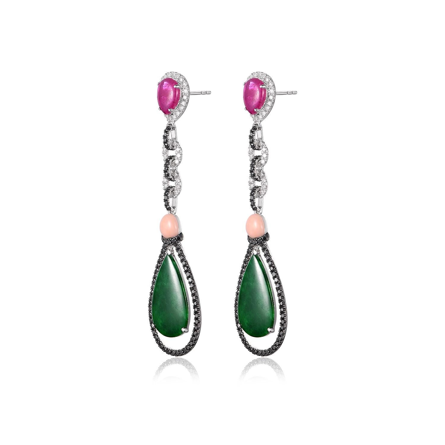 These exquisite vintage drop earrings are a testament to fine craftsmanship and timeless elegance. Crafted in gleaming silver and 18k white gold, they effortlessly combine luxury and sophistication.

At the pinnacle of each earring, a radiant ruby