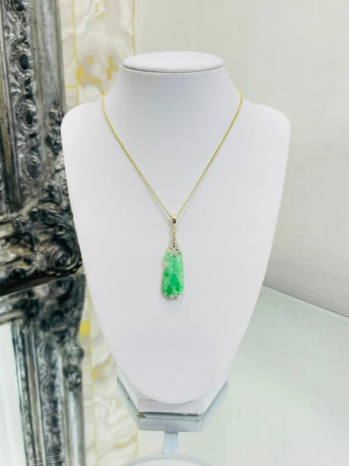 Vintage Jadeite & Diamond Platinum Pendant On A Gold Chain

Hand carved pendant, in a platinum setting with old cut white diamonds and having a yellow gold, top thread through link and chain. 10 x  white diamonds that are set into the pendant